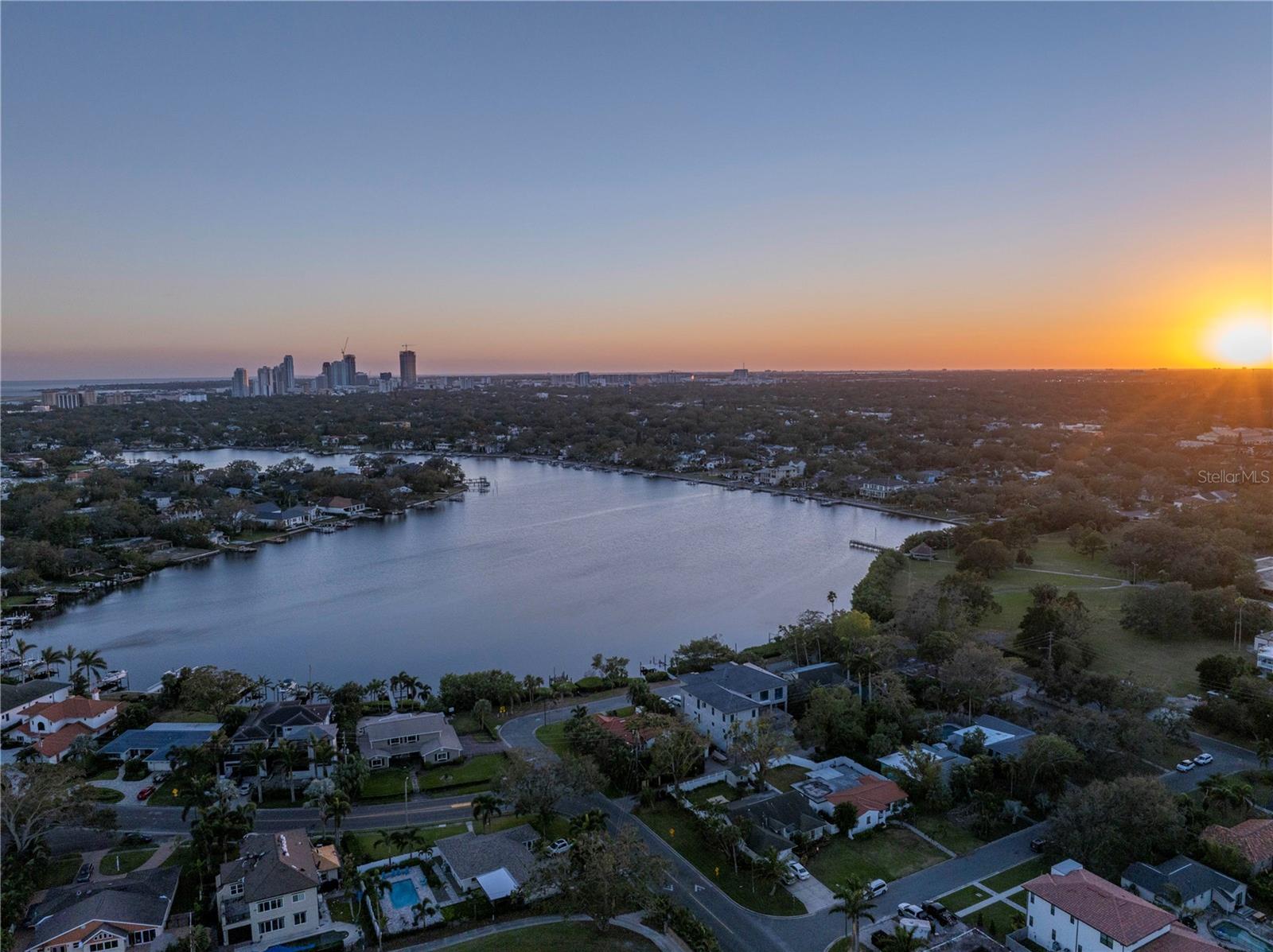 A Coffee Pot Bayou Oasis with WATERFRONT VIEW SECOND TO NONE! This is the property you've been waiting for. Tucked off Monterey Blvd, just steps to the Vinoy Golf course, you'll find 323 Coffee Pot Drive nestled on a practically private street (almost no through traffic) with just four homes facing the incredible skyline of downtown St. Pete. A fantastic opportunity to renovate or build your dream home under the FEMA 49% rule featuring almost 100ft of mangrove protected waterfront paradise, abundant with wildlife and perfect for enjoying the peace and tranquility of bayou living. Fishing, kayaking, bird watching and manatee sightings are all a part of daily life, as well as taking in the incredible sunsets from your own private dock. Originally built in in 1953, this truly spectacular three bedroom, three and a half bath home has been lovingly owned by the same family for more than 30 years and renovated over time to include 2,928 square feet of two-story living space with a massive FIRST FLOOR PRIMARY SUITE and OASIS designed saltwater pool. Over its years of ownership, the home has withstood numerous storms and only experienced water intrusion once, as a result of Hurricane Helene. Fully remediated by Servepro and ready to remake your own! Designed for entertaining, the first floor includes a stunning family room with vaulted ceilings, beautiful natural light, wood burning fireplace and French doors both front and back to maximize the feel of indoor/outdoor living. Formal dining room with water view, and a large, open kitchen with breakfast bar and den. Upstairs, you'll find two spacious guest bedrooms, each with their own private baths, gorgeous hardwood floors and THE MOST BREATHTAKING VIEWS of the bayou, plus a bonus converted attic space perfect for a home office or additional storage. The back yard is a lush and luxurious paradise with lagoon-like pool, travertine pavers, covered back porch and mature tropical landscaping that will make you feel like you are at you're at your own private resort. Located on the northwest edge of Snell Isle, one of the area's most coveted neighborhoods, with easy access to 4th street and two Publix grocery stores as well as an efficient commute to Tampa International Airport. Large, covered parking pad with alley access, giving the new owner plenty of space to add a detached garage with upstairs ADU and income producing potential. DO NOT MISS THIS OPPORTUNITY to own a true gem of St. Petersburg!