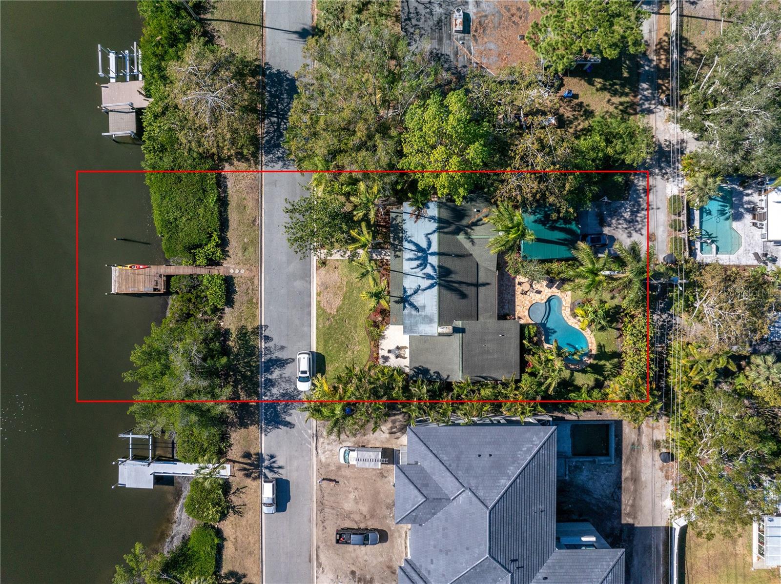 PRICE IMPROVED! BUILD YOUR DREAM HOME or RENOVATE THIS BEAUTY! 95 X 127 lot in PRIME Coffee Pot Bayou LOCATION with WATERFRONT VIEW SECOND TO NONE! This is the property you've been waiting for. Tucked off Monterey Blvd, just steps to the Vinoy Golf course, you'll find 323 Coffee Pot Drive nestled on a practically private street (almost no through traffic) with only four homes facing the incredible skyline of downtown St. Pete. A fantastic opportunity to build or renovate your dream home featuring almost 100ft of mangrove protected waterfront paradise, abundant with wildlife and perfect for enjoying the peace and tranquility of bayou living. Fishing, kayaking, bird watching and manatee sightings are all a part of daily life, as well as taking in the incredible sunsets from your own private dock. Originally built in in 1953, this truly spectacular three bedroom, three and a half bath home has been lovingly owned by the same family for more than 30 years and renovated over time to include 2,928 square feet of two-story living space with a massive FIRST FLOOR PRIMARY SUITE (now with repaired and painted drywall) plus stunning saltwater pool. Over its years of ownership, the home has withstood numerous storms and only experienced water intrusion once, as a result of Hurricane Helene. Fully remediated by Servepro and ready to remake your own! Designed for entertaining, the first floor includes a stunning family room with vaulted ceilings, beautiful natural light, wood burning fireplace and French doors both front and back to maximize the feel of indoor/outdoor living. Formal dining room with water view, and a large, open kitchen with breakfast bar and den. Upstairs, you'll find two spacious guest bedrooms, each with their own private baths, gorgeous hardwood floors and THE MOST BREATHTAKING VIEWS of the bayou, plus a bonus converted attic space perfect for a home office or additional storage. The back yard is a lush and luxurious paradise with lagoon-like pool, travertine pavers, covered back porch and mature tropical landscaping that will make you feel like you are at you're at your own private resort. Located on the northwest edge of Snell Isle, one of the area's most coveted neighborhoods, with easy access to 4th street and two Publix grocery stores as well as an efficient commute to Tampa International Airport. Large, covered parking pad with alley access, giving the new owner plenty of space to add a detached garage with upstairs ADU and income producing potential. DO NOT MISS THIS OPPORTUNITY to own a true gem of St. Petersburg!