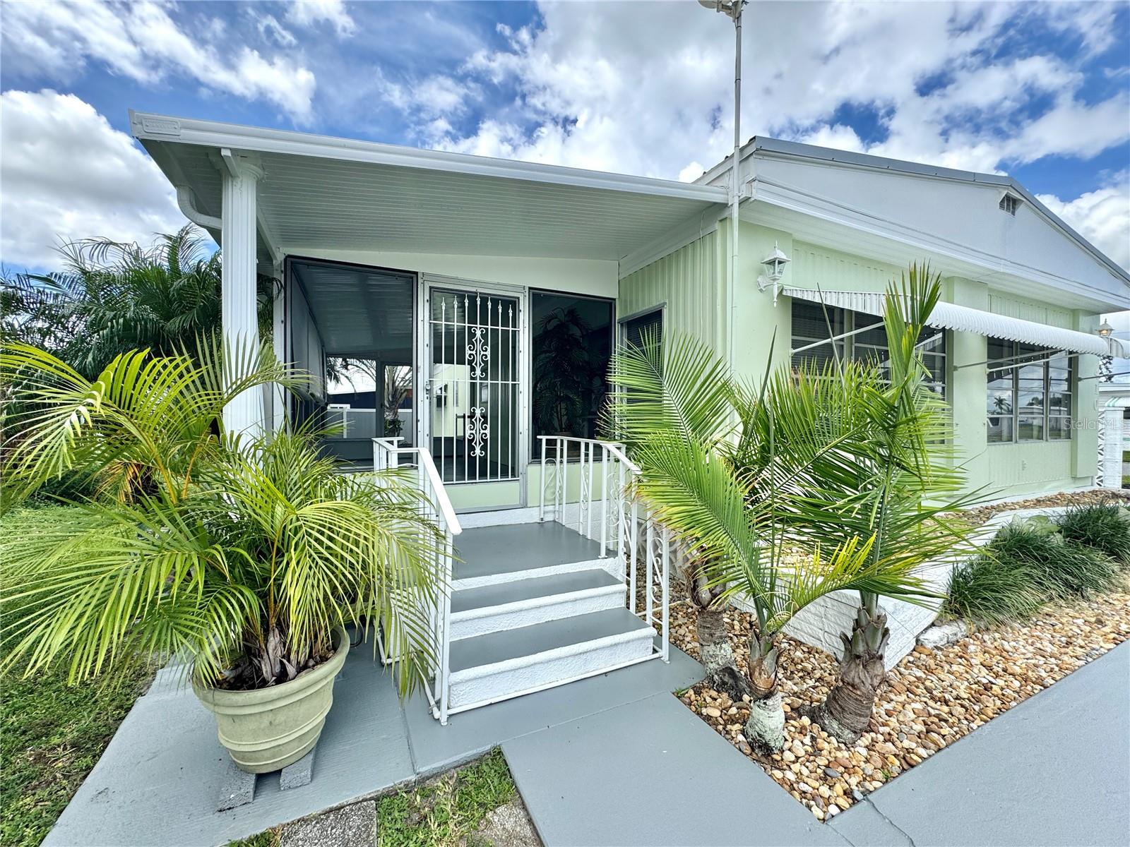 Located in the peaceful and beautifully maintained Heather Hills community, this charming 2-bedroom, 2-bath home offers comfort, convenience, and a welcoming atmosphere. Freshly painted and surrounded by mature landscaping, the home sits on a lovely corner lot with a relaxed neighborhood feel. The spacious, open living area is filled with natural sunlight from large windows that brighten each space, creating a cheerful and inviting environment. Ample storage is found throughout, including a walk-in closet in the guest bedroom and double closets in the primary suite. The primary suite also features a private water closet and a convenient makeup counter. Enjoy the Florida lifestyle year-round from the large screened-in lanai, or bask in the sunshine on the adjoining wooden patio. With landscaping maintenance and garbage pickup included, you can spend more time doing what you love and less time on chores. Electric and water are billed separately. Just minutes from shopping, dining, and everyday conveniences, this well-kept home is ready for its next resident—apply today at no cost.