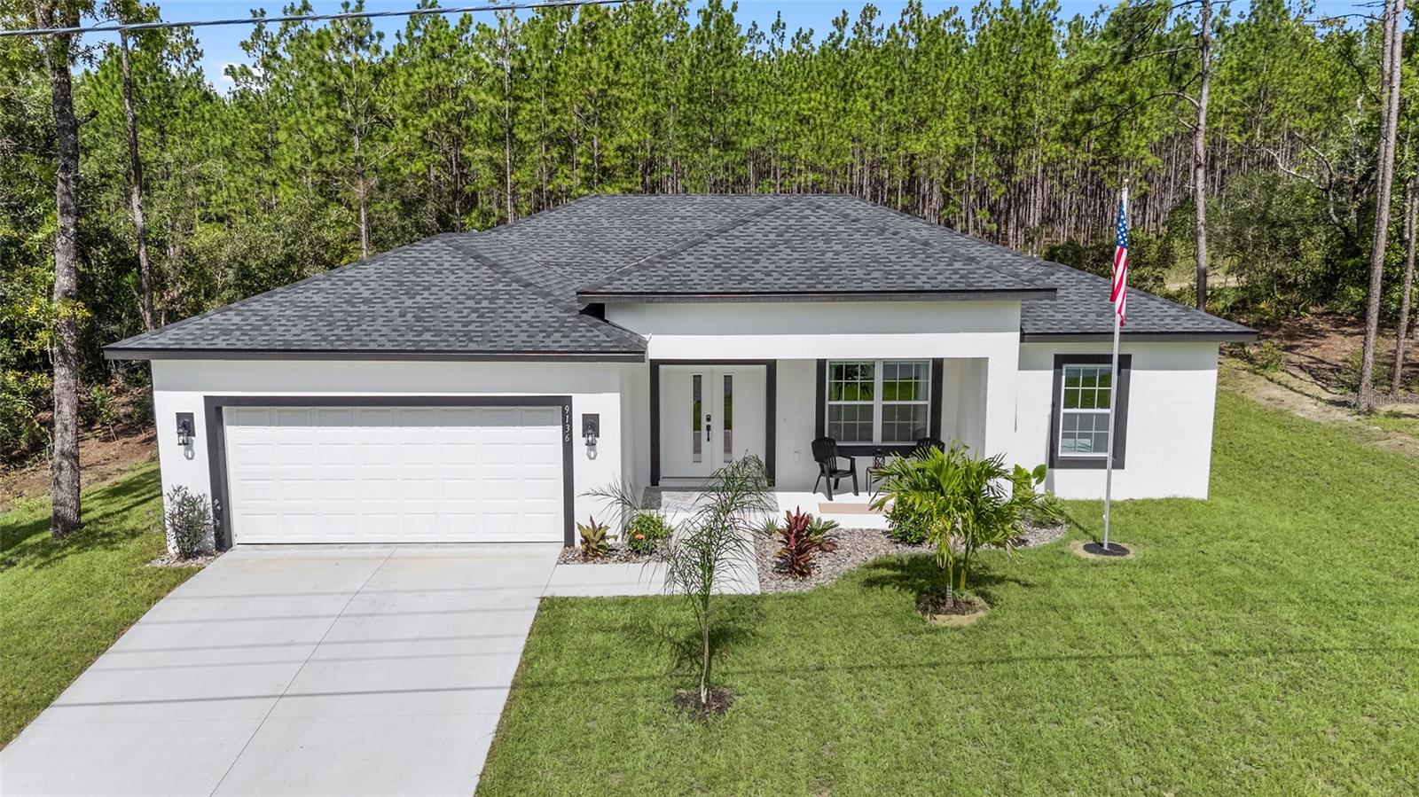 Welcome to this beautifully crafted, LIKE-NEW HOME, BUILT IN 2025 — NO REAR NEIGHBORS located in the PEACEFUL, deed-restricted neighborhood of Citrus Springs with NO HOA! -- Offering 3 spacious bedrooms, 2 full bathrooms, and a 2-car garage, this 1,529 sq ft all-electric home on CITY WATER & SEPTIC SYSTEM was built with quality and care, featuring BLOCK AND STUCCO construction, HIGH CEILINGS, and LUXURY VINYL PLANK FLOORING THROUGHOUT. -- The OPEN LIVING SPACE is warm and inviting with a CUSTOM BUILT-IN ENTERTAINMENT CENTER AND ELECTRIC FIREPLACE, while the dining area is highlighted by a DECORATIVE CHAIR RAIL and 6-globe chandelier on a dimmer. -- The heart of the home is the STUNNING KITCHEN, complete with QUARTZ COUNTERTOPS, SOFT-CLOSE shaker cabinets with crown molding, a large center ISLAND with breakfast bar overhang, SUBWAY TILE BACKSPLASH, corner lazy susan, upgraded faucet, closet pantry, and a full suite of SAMSUNG STAINLESS STEEL APPLIANCES including side-by-side refrigerator, flat-top range with air fry, mounted microwave, and hidden-control dishwasher. -- The private primary suite has two windows to the BACKYARD, a generous 7 Ft x 11 Ft WALK-IN CLOSET, and a LUXURIOUS en-suite bathroom featuring a DUAL-SINK QUARTZ VANITY, recessed lighting, OVERSIZED 10.5 FT X 4 FT TILE SHOWER with MULTIPLE SHOWER HEADS, and private privy. -- The SPLIT FLOOR PLAN includes two more bedrooms with recessed lighting and built-in closets, plus a well-appointed guest bathroom with TILED TUB/SHOWER combo and QUARTZ VANITY. -- Enjoy the convenience of an INSIDE LAUNDRY ROOM with GE washer and GE dryer, utility sink with QUARTZ TOPPED surround, and garage access. -- The home also includes a private mailbox, finished landscaping with rock mulch, a flagpole, and a LARGE 30 Ft x 7 Ft COVERED REAR PATIO overlooking the PEACEFUL BACKYARD. -- This home offers the ideal Florida lifestyle — move-in ready and waiting for you, schedule your private tour TODAY!!