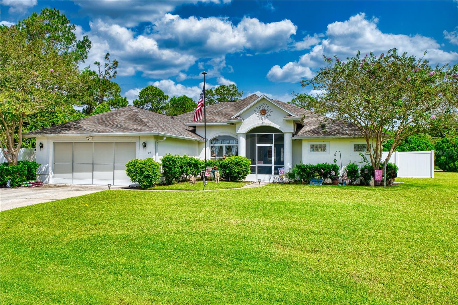 This beautiful pool home resides stately on an oversized corner lot in one of Palm Coast’s most desirable neighborhoods. A fully fenced backyard offers both privacy and functionality, with a dedicated area to store your RV, boat, or trailer securely behind a large double gate. An oversized driveway provides ample parking for guests in addition to the attached garage, which includes a Level 2 EV charger. Outdoors, enjoy a resort-style electric-heated pool with spillover spa and spacious screened enclosure—perfect for entertaining or relaxing day and night. Inside, the open floor plan features tray ceilings, decorative niches, and abundant natural light. The kitchen shines with granite countertops, upgraded wood cabinetry with crown molding, a breakfast bar, and casual dining nook overlooking the pool. The owner’s suite is a private retreat with its added sitting area, pool access, and a spa-inspired bath featuring double granite vanities, jetted tub with glass block detail, and a walk-in shower with glass surround. With thoughtful upgrades throughout and plenty of space for your toys, this home combines elegance, convenience, and the best of Florida living.