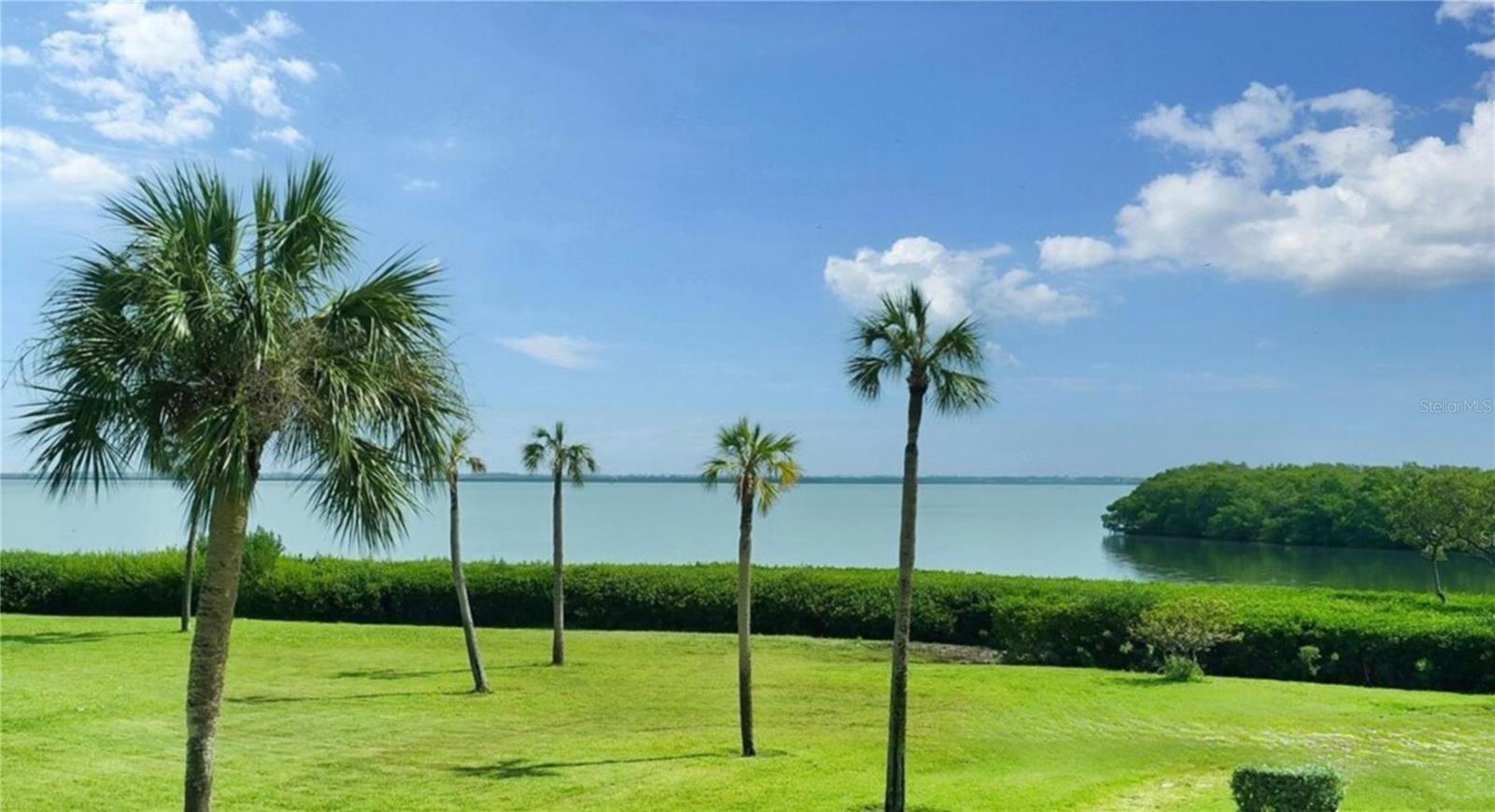 HUGE PRICE REDUCTION - THIS IS YOUR OPPORTUNITY TO HAVE A BAY FRONT CONDO AT A GREAT PRICE - $550,000! Welcome to your bay front condo on Longboat Key, where every day begins with breathtaking sunrises and panoramic views of Sarasota Bay. This updated and partially furnished 2-bedroom, 2-bathroom residence features easy to maintain tile throughout the main living spaces, creating a streamlined aesthetic and easy living. The open-concept great room flows seamlessly into the updated kitchen complete with stainless appliances, granite counters, and a westerly facing window for enjoying stunning sunsets over the Gulf of Mexico. Each evening, you'll also enjoy moonrises reflecting off the bay and gentle breezes over the serene waters from your 22-foot wall of floor-to-ceiling windows in the Florida room, a perfect backdrop for relaxation or entertaining. The primary bedroom, nestled at the far end of the home for privacy, offers more bay views, direct access to the Florida room, and a generously sized ensuite bathroom with walk-in closet and conveniently placed laundry. The second bedroom, equally serene, also boasts bay views, direct access to the Florida room, and is served by an adjacent updated bathroom, ensuring comfort and privacy for your guests. This condo offers peace of mind with 2019 hurricane-rated windows, a 2019 HVAC system, and a 2019 water heater. Underbuilding parking and a private storage room provide additional convenience and value. Plus, one of the two community pools is just outside your front door, adding to the fun and ease of your tropical lifestyle. Located in the sought-after Windward Bay community, this lushly landscaped oasis is 26 acres and .5 mile long of direct bay front property, offering an unparalleled low density, serene living experience. There are fruit trees, walking/biking paths, picnic tables, and fire pits for your pleasure. Residents can also enjoy a wide range of amenities, including two boat basins with slips available for rent ($40/month or $45/month with an owner-supplied lift), kayak launches and storage ($35/year), fishing with fish cleaning stations, three beach accesses directly across the street, plus a large clubhouse with gathering space, catering kitchen, fitness center, locker rooms, and saunas. Additional recreational facilities include 2 heated pools with sundecks and complimentary chaises, shuffleboard, tennis, and pickleball courts. Ensuring peace of mind for years to come, this community is meticulously maintained with freshly painted buildings, new roofs, and a recently passed Milestone Integrity Inspection that certifies the buildings for another 10 years. The rental policy is flexible, with a one-month minimum or longer rental period allowed up to 2/year, and owners can rent immediately upon ownership without a waiting period. Beyond the on-site amenities, the unbeatable location is just a short drive from the restaurants, shops, and cultural activities of Saint Armands Circle and downtown Sarasota. For fine dining, the Zota Beach Resort is right across the street, and the nearby Centre Shops offer everything from Pilates and a diner to a seafood restaurant, ice cream shop, bank, and boutiques. Seller has paid Special Assessments. No Special Assessments are due from Buyer.