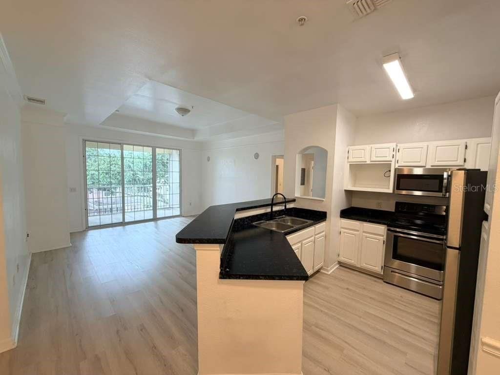 Photo of 6413 Astor Village Avenue #301, Orlando, FL 32835 (MLS # O6419116)