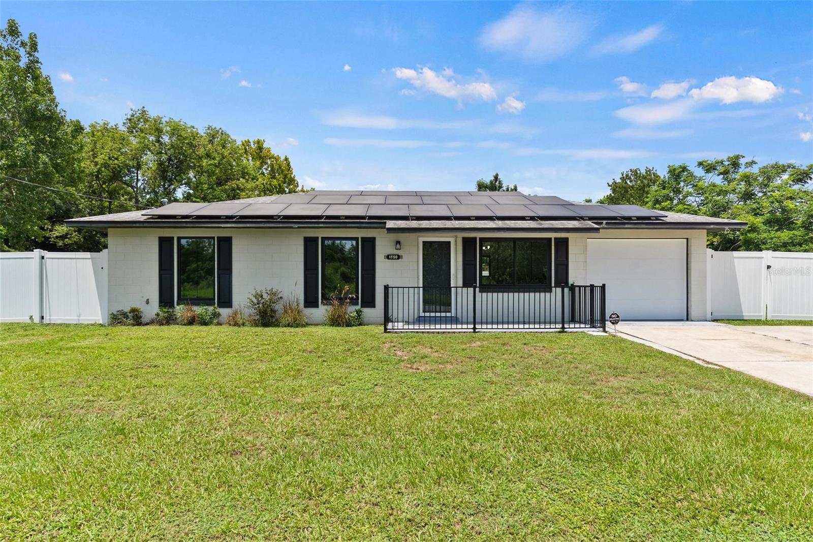 You must see this immaculate 3-bedroom, 1.5-bath home in Tavares with no HOA! Light and bright interior featuring a remodeled kitchen with new flat-top range, large farmhouse sink, and abundant cabinet/counter space. Laminate wood floors throughout. Updated full bath with new vanity. Tankless water heater, one car garage and a fully fenced yard. Located near shopping, dining, and banking—just minutes from Downtown Tavares, “America’s Seaplane City.”