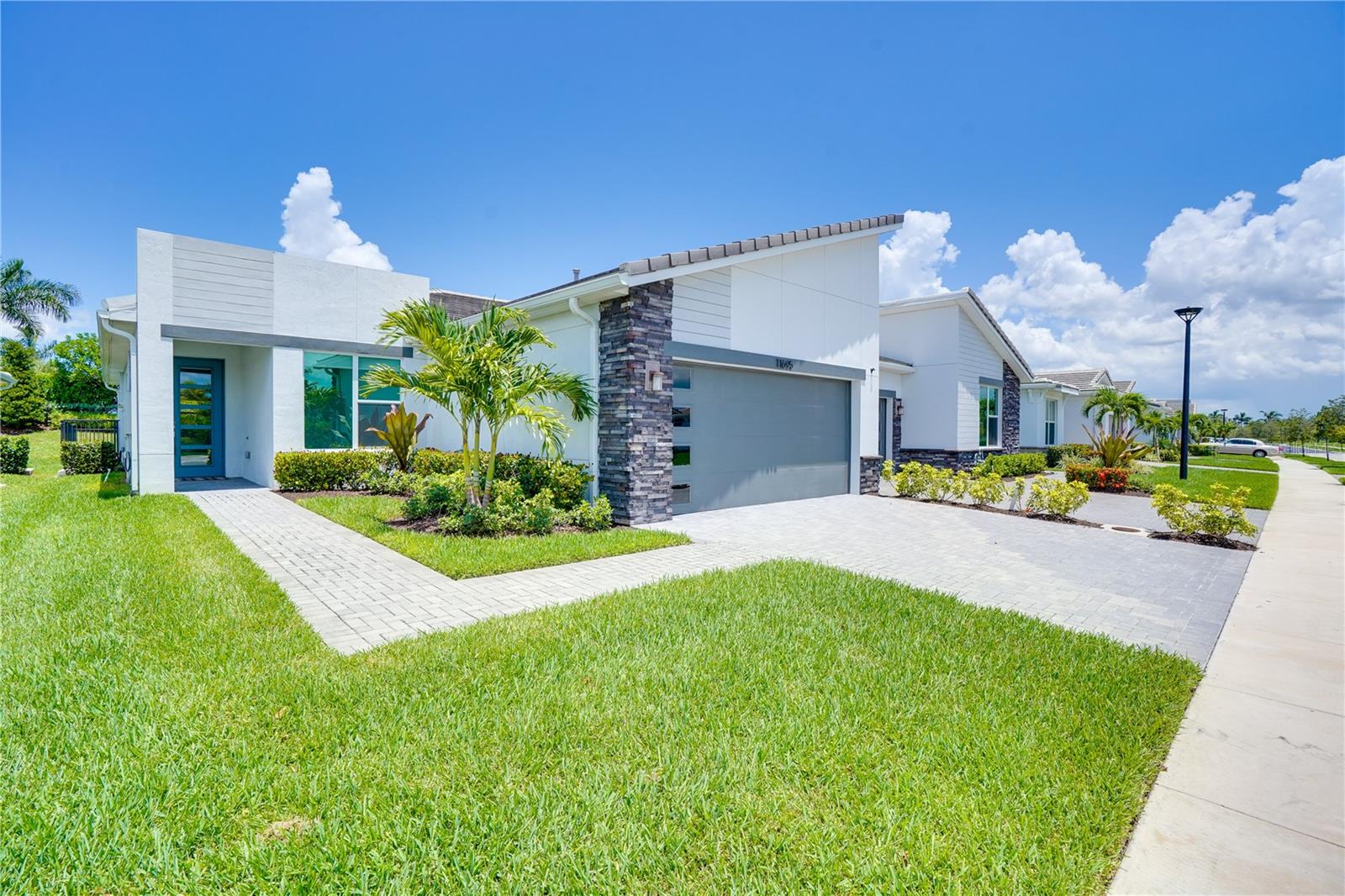 One or more photo(s) has been virtually staged. Stunning move-in-ready villa in the gated community of Telaro at Southern Grove in the heart of Tradition. Live everyday like you’re on vacation in this open concept 2 Bedroom, 2 Bathroom + Den home. Natural light shines through this home, featuring a large great room allowing for an open kitchen, living and dining area, great for entertaining. Kitchen features quartz countertops, gas range, a center island and custom lighting. A den off the great room could easily be turned into a 3rd bedroom, be used as an office or a hobby room. Enjoy your oversized screened in patio stretching almost 24 feet long, allowing plenty of room for chairs, table, dining area and even a hot tub. Fenced in backyard is perfect for pets and offers room to add a pool. Private backyard including a beautifully landscaped berm with no neighbors behind. The primary bedroom retreat can fit a king sized bed with large nightstands on both sides. Primary bathroom feels like a spa and features quartz countertop, double sinks, custom tile shower and a large walk in closet. The split bedroom floor plan features a second bathroom and guest bathroom in the front of the home, along with a spacious laundry room, linen closet and kitchen pantry. Custom window shades featured throughout. Impact windows and CBS construction lend peace of mind to this move-in-ready home. Two car garage with a paver driveway allows room for multiple cars. Telaro just completed a magnificent 20,000 square foot clubhouse. Inside you have access to a grand hall, lounge area, demonstration kitchen, card room, wine room, craft room, grab and go cafe, saunas and massage room. Outside you will find plenty of shaded seating areas, resort style pools, a zen garden, basketball, bocce ball, pickelball, and tennis courts. Vibrant community with a robust calendar of events including wine club, cooking club, poker club, tennis club, book club, yoga club and more. Come experience a resort lifestyle. Located right near the Heart at the Park, the latest Port Saint Lucie attraction and restaurants like Kyle G’s Chophouse, Sara’s Kitchen, Robeks Juice. Minutes from The Fresh Market, Target, Publix and shopping at the Landing at Tradition. Tradition Town Center is home to a Sunday farmer’s market and a variety of community events. Conveniently located near I-95 and easily accesible to Palm Beach International Airport.
