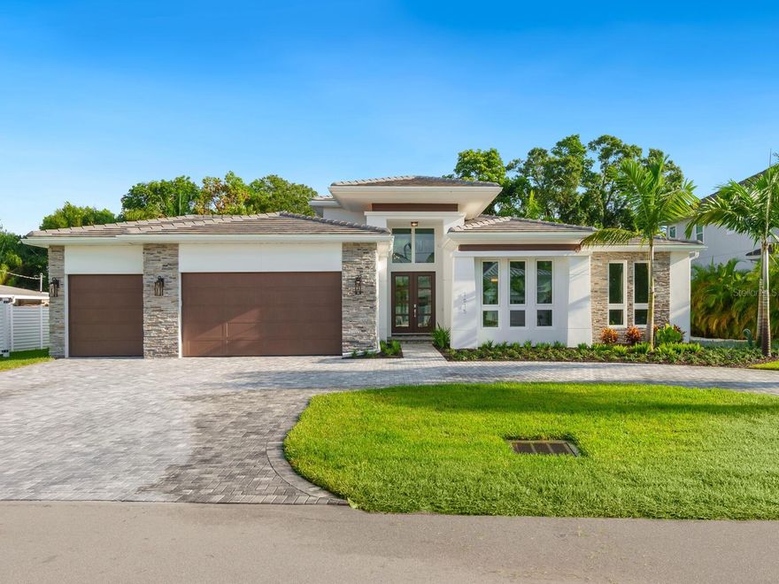 Under Construction. Luxurious amenities define this fabulous new residence in Oyster Bay Estates that’s been masterfully planned and executed with attention to detail that’s second to none. The enticing “Kristi Ann Modern” plan is an artful creation of award-winning Allegra Homes and has been designed for ease of living throughout it’s 3,023 square feet in the main house plus a separate 360 square foot en-suite casita. Offered in the main house are 3 en-suite bedrooms, study with built-ins, bonus room with wet bar and pool bath, and great room with a high ceiling accented by gorgeous double tray detailing, 74” electric fireplace and wall of sliders bringing the outdoors in. The owner’s suite has direct access to the pool area and is adjacent to the study with built-ins. Opening to the great room is a stunning kitchen with a great lineup of features including SubZero side-by-side refrigerator, Wolf cooktop and oven, ASKO Premier ultra-quiet dishwasher, under counter lighting, island, and walk-in pantry. A beautiful built-in buffet with wine cooler enhances the dining area. The screened-enclosed outdoor area is expansive with its extended covered lanai, granite paver decking, fully equipped summer kitchen, heated saltwater pool, 3-tier spa, sun shelf with lighted bubblers, and 2 water bowls. Additional details include Nuvelle oak floors, closet built-ins, gas tankless water heater, Moen fixtures, Kohler plumbing accessories, central vac, pool alarm system, 3-zone Trane A/C, hurricane Low-E windows and doors, cabinet panel fronted appliances, 3-car garage, covered front porch, foyer entry, professional mature landscaping and deep irrigation well. This desirable address is centrally located near all the wonder and excitement Sarasota has to offer. **Photos are of a different home. Selections and floor plan may vary**