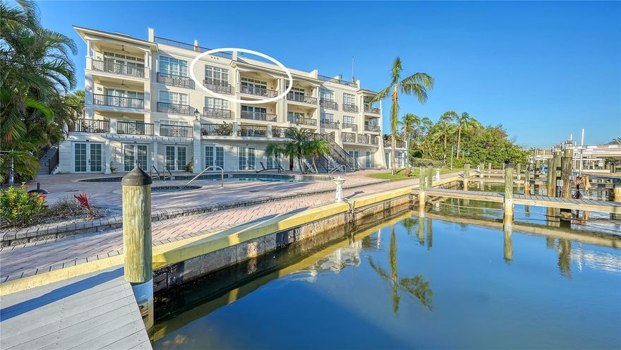 Welcome to Hudson Crossing, a quaint waterfront enclave of just 12 residences perfectly situated in the heart of downtown Sarasota. This sought-after location offers the best of both worlds: a peaceful, close-knit neighborhood combined with immediate access to Sarasota’s vibrant bayfront city life. Nestled across from the beautifully revitalized Selby Gardens, this prime spot is ideal for those who enjoy cultural, culinary, and coastal delights. This exceptional three-bedroom waterfront residence is a rare find, offering all the conveniences of condominium living with the privacy and feel of a single-family home. Thoughtfully designed, it boasts a two-car garage, ground-level storage unit, a private rooftop terrace, and a deeded boat dock fulfilling every lifestyle desire. Move-in ready and impeccably maintained, the home spans more than 2,500 square feet of living space, featuring vaulted ceilings, beautiful wood floors throughout and a contemporary layout designed for both comfort and entertaining. The open-concept kitchen and great room form the heart of the home. The chef’s kitchen is outfitted with custom cabinetry, a tile backsplash, stainless steel Wolf and Bosch appliances, including a five-burner gas cooktop, breakfast bar, and pantry. Adjacent, the living and dining areas are bright and inviting, highlighted by a wall of impact glass sliders that open to a waterfront terrace. This seamless indoor-outdoor connection makes it easy to enjoy tranquil water views and Sarasota’s year-round sunshine. The primary suite is a serene retreat. It features a spacious walk-in closet with custom built-ins, luxurious quartz bathroom, and direct access to the waterfront terrace. On the opposite side of the residence, two additional bedrooms offer versatile spaces for guests or a home office. Both feature walk-in closets, with the third bedroom currently styled as an office/library. The crown jewel of this home is its own exclusive rooftop terrace, a secluded oasis reserved only for penthouse residents. This private space is perfect for entertaining, complete with a granite summer kitchen, built-in Lynx grill, and ample room to dine, lounge, or simply enjoy panoramic water views. For boating enthusiasts, the deeded dock offers direct access to Sarasota Bay, the John Ringling Bridge, and Marina Jack, making this an unparalleled waterfront lifestyle. Hudson Crossing offers more than a home; it provides a lifestyle of elegance, charm, and convenience in one of Sarasota’s most desirable locations. From biking along the Bayfront to exploring theaters, museums, trendy boutiques, and Sarasota’s renowned Main Street Farmer’s Market, every day offers a new adventure. Just minutes away, the Gulf’s pristine beaches add the finishing touch to your Florida lifestyle.