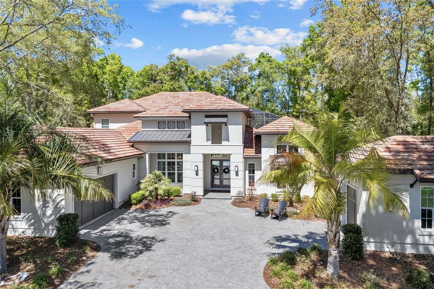 Welcome to this exquisite Mediterranean-style residence nestled in the esteemed Oakmont neighborhood of Gainesville, FL. Boasting five bedrooms, five and a half bathrooms, and a spacious office, this luxurious home offers an unparalleled blend of sophistication and functionality.
Upon entry, guests are welcomed into a grand foyer leading to the expansive living area adorned with intricate architectural details and soaring ceilings. The gourmet kitchen, equipped with top-of-the-line appliances and a central island, is a chef's delight, while the adjacent dining area offers serene views of the lush backyard oasis.
Step outside to discover your own private paradise, complete with a screened-in pool area, outdoor kitchen, and cozy seating next to the gas fireplace. The pool, featuring a spa and wade-in seating area, invites relaxation and entertainment year-round. Additionally, a separate casita provides an additional bedroom and full bathroom, perfect for accommodating guests or enjoying a private retreat.
Ascending the staircase, you'll find a second-story living space with a balcony offering sweeping views of the pool area below. Each bedroom is generously sized and thoughtfully appointed, ensuring comfort and privacy for all occupants.
Beyond the bedrooms, a large office provides a dedicated space for work or study, enhancing the home's versatility and appeal. The home is equipped with Control 4 Smart Home features as well. There are several refrigerators throughout the house, including one upstairs, another in the laundry and of course the bar is equipped with a wine fridge as well.
With its impeccable design, luxurious amenities, and prime location, this Mediterranean masterpiece epitomizes the epitome of Florida living in the prestigious Oakmont neighborhood.