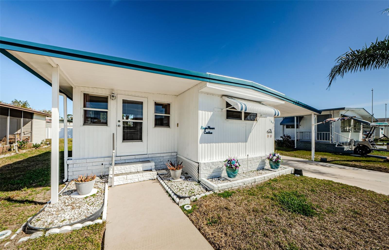 PRICED TO SELL! Charming & Move-In Ready Home in the highly sought-after Tarpon Shores 55+ Community –Discover the perfect blend of comfort, privacy, and resort-style living, where YOU OWN A SHARE IN THE CO-OP! No LOT RENT! The $40K share price is included in the list price and can be financed through the CO-OP. NO FLOOD OR WIND DAMAGE from recent storms! Enjoy peace and tranquility with no rear neighbors, offering extra privacy and outdoor space. Step inside this beautifully maintained home, where tasteful updates and a spacious layout make it truly move-in ready. The large Florida room, vented for heat and air, doubles as a second bedroom with a sleeper sofa—perfect for guests. The bright and inviting living room provides plenty of space for both relaxation and entertaining. The generously sized primary bedroom features a built-in closet and drawers, plus a ceiling fan with light fixture. The updated bathroom offers a step-in shower with grab bars and a linen closet for extra storage. All furnishings and appliances, including the microwave oven and Whirlpool washer and dryer, are optionally included, making this home a seamless move-in opportunity. NOTABLE RECENT UPDATES: include a brand-new HVAC system (2023), and a durable metal roof with a roof-over (2010). The floors are solid with New Sub-flooring and easy-care laminate flooring throughout most of the house, and New Vapor Barrier (2010). Tile in the Kitchen and carpet in the Florida room for added comfort. Close Proximity to the community office, clubhouse, and heated pool, this home is in a prime location within Tarpon Shores. This vibrant, friendly community offers resort-style amenities, including a large clubhouse, heated pool, BBQ grills, a fully equipped kitchen, a library, billiard room, covered shuffleboard courts, bocce ball, pickleball, horseshoe pits, and a calendar full of social activities and monthly newsletters. Enjoy affordable, MAINTENANCE-FREE LIVING WITH A LOW MONTHLY HOA FEE OF $315, covering lawn mowing, lawn spraying (fertilizer, insecticide, and weed control), water, sewer, trash pickup, cable TV with a park information channel, and internet. Plus, no additional fees, no special assessments, and low taxes—all in a non-flood hazard zone. Nearby golfing, the Pinellas Trail, boating, shopping, fine dining, and breathtaking sunsets just minutes away. This is your chance to own a home in one of Tarpon Springs' best 55+ communities. Check out the virtual tour and schedule your private showing today!