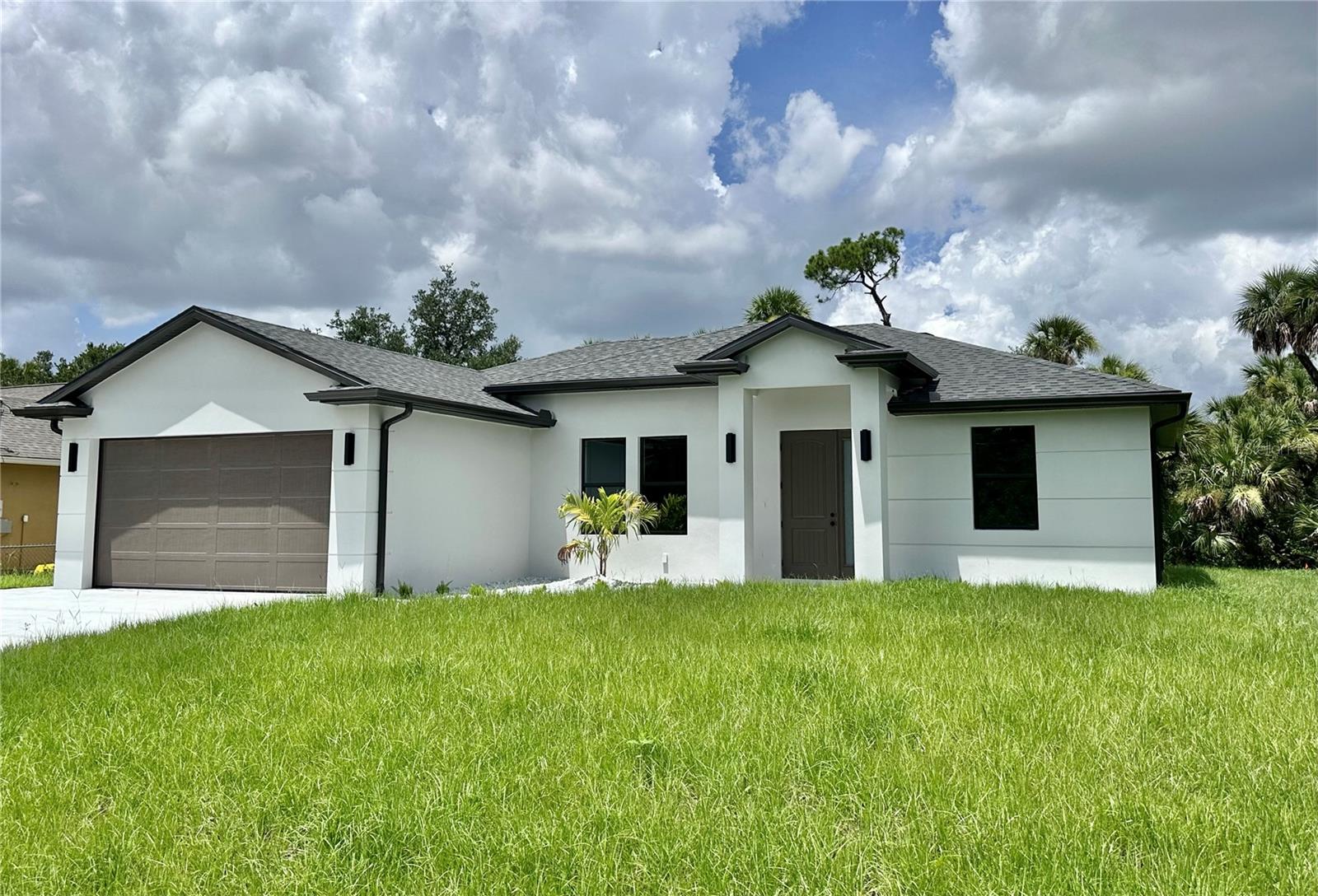 BRAND NEW 2025 CUSTOM BUILT HOME meticulously crafted to the latest building codes and is MOVE IN READY! NOT IN A FLOOD ZONE! Over 2,220 total square feet is ready for you to enjoy Florida Lifestyle. Open concept floor plan, featuring 3 Bedrooms, 2 Bathrooms, 2 car garage, and beautiful porch/lanai. This home is equipped with many upgrades - IMPACT WINDOWS AND DOORS, WATERPROOF LUXURY VINYL FLOORS, Chef's dream KITCHEN EQUIPPED WITH TALL DOUBLE-STACKED SOFT-CLOSE CABINETS, QUARTS COUNTERTOPS, TILE BACKSPLASH, PROFESSIONAL-GRADE APPLIANCES, and a LARGE CENTER ISLAND. Light and airy color combination throughout, infusing the home with an atmosphere of effortless elegance and tranquility. Soaring high ceilings, accentuated by a TRAY CEILING IN THE MASTER BEDROOM while CEILING FANS provide gentle breezes in every room. A spacious INSIDE LAUNDRY ROOM complete with WALL CABINETS, adds convenience to daily living. Custom interior doors, and tall baseboards frame the home with sophistication. Master suite includes 2-WALK IN CLOSETS, DOUBLE VANITY, BEAUTIFUL WALK-IN SHOWER. Great size backyard with plenty of room for your POOL! Gorgeous color combination throughout the home. Located in a desirable location in the growing City of North Port - yet very close to Port Charlotte! Minutes away from World Famous Mineral Springs, North Port's Aquatic Center, Schools, Shopping's and Dining's. Short Drive away from Beautiful Sandy Beaches. Don't wait, schedule your private showing today!