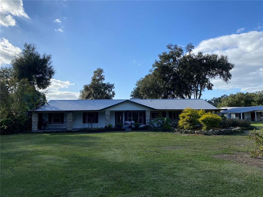 Discover a rural retreat in Oxford, FL - 40-acres of paradise awaiting you. Nestled among the gorgeous land is an expansive 2,300 sqft home with 2 bedrooms and 2 bathrooms, a study/den, plus additional buildings to house all your farming equipment needs; including one 3,584 sq ft covered barn with a 768 sq ft mother-in-law suite. The mother-in-law suite offers two bedrooms & one bath along with an office perfect for working from home or entertaining guests. An 1,188 sq ft 3 bay garage with storage and/or additional laundry room. 572 sq ft carport. An additional 960 sq ft barn/garage. Eight 12x12 horse stalls and cattle pens. Make this your private getaway surrounded by fenced pastures for horses and cattle alike! The property can also be divided into eight 5 acre parcels if desired. Interior finishes of the home include Cypress, Red Cedar, Cherry Laurel, River Heart Pecky Cypress, Western Cedar, Douglas Fir, Blue Pine, and Camphor. SEE ATTACHED BROCHURE