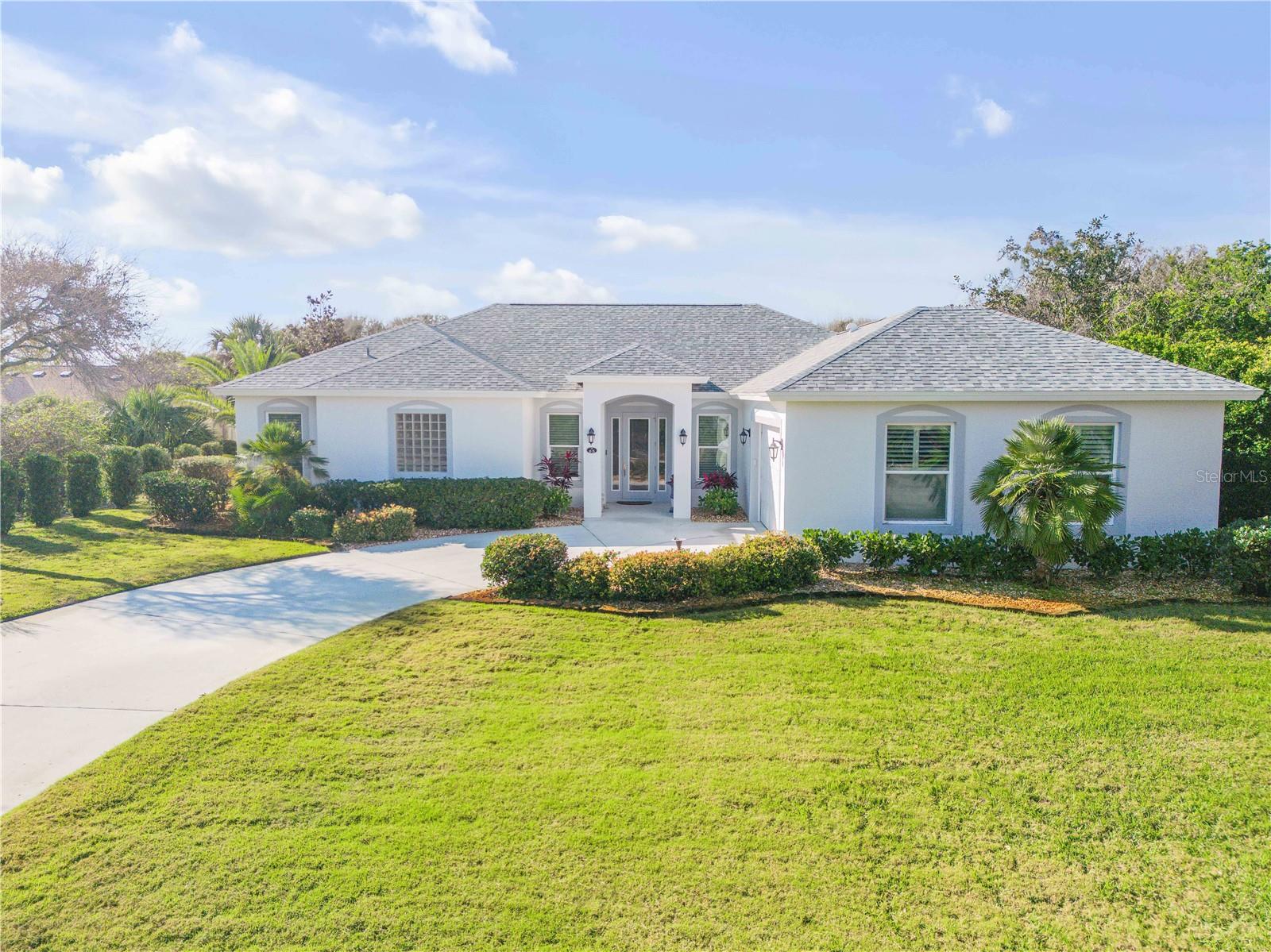 Welcome to your private oasis in Ponce Inlet, where coastal elegance meets luxurious living. This custom-built three-bedroom, three-bath home offers 2,232 square feet of meticulously crafted living space designed for those who appreciate comfort and sophistication in their lifestyle. Ideal for those seeking a vibrant yet serene beachside retreat, this home is ideal for entertaining family and friends or simply relaxing in style. As you enter, you're greeted by a spacious floor plan with 9-foot ceilings that seamlessly blend the living and dining areas. A beautiful dual-sided gas fireplace serves as a central feature, creating a warm and inviting ambiance that can be enjoyed from the living room and primary suite. Whether you're entertaining in the living room or unwinding in your private retreat, this fireplace adds a touch of elegance and comfort to both spaces. The chef-inspired kitchen is a dream come true, with a large center island, wall oven, and ample counter space that make cooking and hosting a breeze. Whether you're preparing meals or gathering with loved ones, this kitchen is designed for functionality and beauty. Retreat to the luxurious primary suite, a tranquil sanctuary offering a spacious layout and a pass-through bath with a spa-like walk-in shower and soaking tub. It's the ideal place to relax after a long day, with plenty of space to unwind. For added convenience, the home features a whole-house water filtration system to ensure pristine water quality throughout, along with a home system Generac backup generator that offers peace of mind during unexpected power outages. The home also features two propane tankless water heaters. Step outside to your serene, private backyard, where lush landscaping surrounds you in natural beauty. A Meyer lemon tree adds a refreshing touch of citrus, while the bird feeder area provides an inviting space to watch local wildlife right outside your window. Relax and take in the view from your screened-in back porch, an ideal spot for enjoying the peaceful surroundings year-round. In the heart of Ponce Inlet, this home provides easy access to the beach, boating and all coastal living has to offer, while being conveniently close to Daytona Beach and Orlando's top attractions. Enjoy an active lifestyle with nearby biking, pickleball, golf, tennis and boating opportunities. This is more than just a home, it's a lifestyle. Embrace the blend of luxury, comfort and tranquility in this stunning Ponce Inlet property. Welcome home! By appointment only.