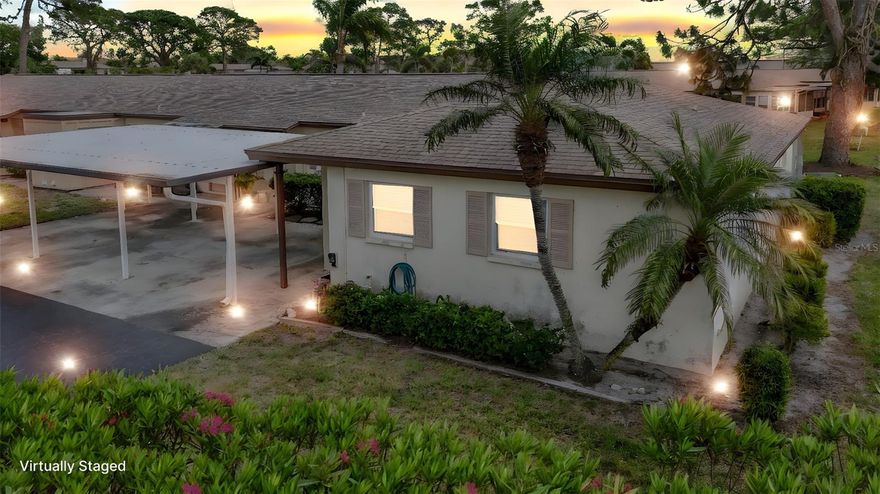 PRICE REDUCED on this cozy 2-bedroom, 2-bath paired villa is conveniently located in Sarasota, just three mile, 25 minute bike ride from the world-renowned Siesta Key Beach and just five miles from downtown Sarasota and all of the art, culture and fine dining. This community is a short walk to shopping, dining and public transportation. This end unit is light and bright and has a large rear porch, tile floors, a carport, and guest parking. All of the windows except for the sliding door are storm-rated and impact resistant.   This villa comes equipped with a washer and dryer. Both bedrooms are comfortably generously sized. . The kitchen opens to the great room and has a popular open-concept plan, which is perfect for entertaining! This villa is priced below market and needs a little love. As part of this friendly 55+ community, you'll enjoy an active, social lifestyle. Spend your days relaxing by the pool, grilling at the clubhouse with friends, playing shuffleboard or bacci ball or joining one of the many social activities, from shuffleboard to Mahjong, bocce ball, and monthly potlucks. Whether you're looking to enjoy Florida sunshine for a season or a full-time residence, this home offers the best of Florida living. This is very well priced and will sell fast!  and experience this charming home for yourself!