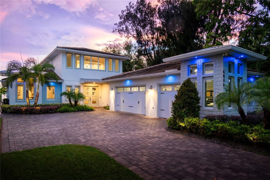 Nestled along the serene shores of the pristine Lake Conway chain of lakes, this coastal modern masterpiece embodies luxury living at its finest. Boasting over 70 feet of coveted waterfrontage, this stunning property offers a rare opportunity to indulge in waterfront bliss. Upon arrival, a grand entrance welcomes you, with a long driveway lined with majestic fox-tail palms, setting the tone for the elegance that awaits. The home's exterior is adorned with mature landscaping, expertly illuminated with uplighting, creating a captivating ambiance day or night. Step inside to discover an impeccably designed residence spanning 3,900 square feet, featuring four bedrooms and four and a half bathrooms, plus an office. Each bedroom offers the ultimate retreat with its own ensuite bathroom and spacious walk-in closet, ensuring comfort and privacy for all. The primary bathroom is a sanctuary unto itself, showcasing an oversized shower for two, perfect for unwinding after a day on the lake. Coastal modern finishes grace every corner, marrying sophistication with coastal charm. Entertain with ease in the expansive outdoor oasis, complete with a dock equipped with a dual motor lift for larger boats and a dual jet ski lift, catering to the avid boater's every need. Lounge by the sparkling pool, adorned with bubblers and accent lights, offering a refreshing respite on hot summer days. As evening falls, gather around the wood-burning fire pit pavilion, where stories are shared and memories are made under the starlit sky. For added convenience, the property features a mosquito misting system and phantom screens, ensuring uninterrupted enjoyment of the outdoors. The oversized 3-car garage provides ample storage for vehicles and recreational gear, while a stand-up attic offers additional space for belongings. Indulge in the epitome of lakeside luxury living at this breathtaking Lake Conway retreat, where every detail has been meticulously curated for the discerning homeowner seeking the ultimate waterfront lifestyle.