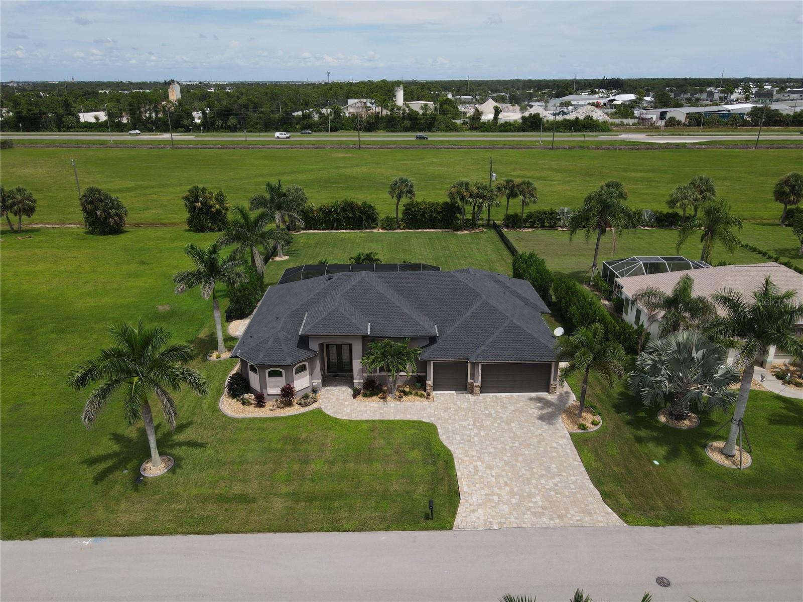 Welcome to Burnt Store Meadows and this amazing 2017 custom built 2616 sq. ft. 4 bedroom, 3 bathroom with a 3 car garage and pool home. The pictures can not do this home justice as it is even nicer in person. As soon as you pull into the oversized brick paver driveway you will notice that this home should be in Better Homes and Gardens as the landscaping is second to none in this neighborhood. This home sits on a oversized 20,000 sq. ft. lot with a fenced in backyard. The pool area and backyard is like a huge playground for the little ones or your favorite pet. Brick paver side walks give you access from the front to back and you still haven't even made it inside yet. The 3 car garage has a commercial epoxy floor already done with additional overhead storage already installed. Once you go inside you will notice how many extras were put into this home such as high ceilings with tray recesses and double crown molding. Plank looking porcelain tile runs throughout the entire home except for the mother in law suite. There is an additional room that adjoins one of the bedrooms and is an additional 15 x 12 that is a mother in law type set up with a private bathroom and a huge walk in closet. The kitchen has plenty of cabinet space and granite counter tops that compliment the stainless steel appliances. All interior doors are 8 ft intead of standard 7 ft. doors. The primary room measures in at 16 x 15 and overlooks the pool and backyard areas. A large 12 x 7 walk in closet gives you lots of room for storage. A his and her sink set up in the primary bathroom is complimented by a double entry walk in shower area that is finished off with swinging tempered glass doors. The entire living area is like one large great room and it has a spectacular view of the pool area and back yard through 8 ft. hurricane rated triple slider pocket doors that makes the 30 x 10 ft. covered lanai feel like an extension of the family room. Such a great set up for entertaining or holidays with the family. The pool says it all with the phrase "Its 5 O'clock somewhere" as this home feels like it is full of fun! A water softner is also already installed. The location of this home and neighborhood is also hard to beat as a Home Depot and Publix Shopping Center is literally just minutes away and a Walmart is right around the corner. Downtown Punta Gorda and all it has to enjoy is just minutes away as well. You can walk downtown on the miles long walking path as it winds itself down the water side of the Charlotte Harbor. You will see the war memorial, a huge playground area at the park and you can stop and learn about so many iconic spots as well. There is the fan favorite farmers market every Saturday morning, the Christmas tree lighting ceremony, all the different cuisines to choose from at your favorite restaurants along with sports bars and your favorite pubs. Of course everyone loves sitting and enjoy a great meal at Titi's overlooking the Charlotte Harbor. For all you golfing enthusiast, there is 8 different golf courses within a 20 minute drive and multiple places around town to put the boat or wave runners in the water. And don't forget about all the Pickleball courts! This home being priced at $268 a sq. ft. is simply to good to pass up, so hurry now to set up your showing before this home is gone.