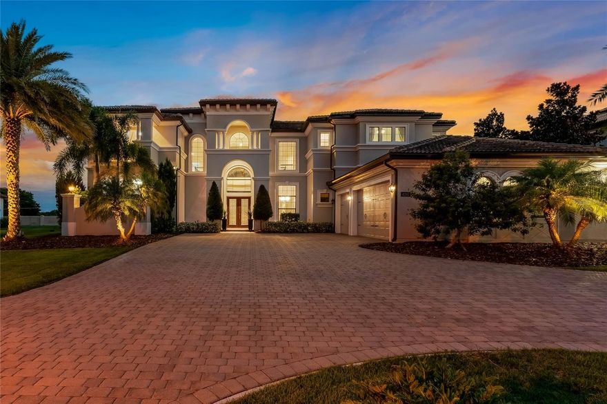 Location! Location! Location! This luxurious estate home in the sought-after Casabella gated community in Windermere offers a piece of paradise, with a private resort-style saltwater heated pool and spa with outdoor kitchen complete with a grill, refrigerator and sink, ideal for alfresco dining. There is also an outdoor shower with hot and cold water, and ample lounging space under an extended covered lanai for relaxation and entertainment, with the added bonus of nightly Disney fireworks viewed from your backyard. Inside, the grand foyer leads to the great room with soaring ceilings and a dramatic wall of windows that frame breathtaking views of the expansive saltwater pool and spa. The chef's kitchen is open to the family room and boasts a massive quartz island, oversized Sub-Zero refrigerator and freezer, JennAir double ovens, microwave, six-burner gas range and walk-in pantry. Enjoy meals in the breakfast nook or entertain effortlessly with a wet bar, wine refrigerator, Butler's pantry and formal dining room. The main floor features a stunning primary suite with coffered ceiling and sitting room, pool views and access, a massage room/gym, dual walk-in closets, and a luxurious spa-like primary bath with dual vanities with marble countertops, jetted soaking tub, large walk-in shower and dual water closets. Additional first-floor features include an executive office with pocket French doors, a guest bedroom with an en-suite bath and two half baths. Upstairs in the theater, enjoy a movie or watch the game on the 110-inch screen with a custom surround sound entertainment system. A secondary primary suite upstairs offers a private balcony with pool and pond views. There are three additional well-appointed upstairs bedrooms, each with en-suite baths. One of these bedrooms also has a private balcony. With smart home technology, HVAC air cleaning system and numerous upgrades, this home offers luxury and convenience. Conveniently near Winter Garden Village, shopping, dining and entertainment, and within proximity to Disney, Universal, SeaWorld and the airport. Top-rated public and private schools are just minutes away, making this an ideal home for families. Discover luxury, comfort and convenience in this exquisite Windermere estate, offering endless opportunities for family gatherings and enjoying the quintessential Florida lifestyle.