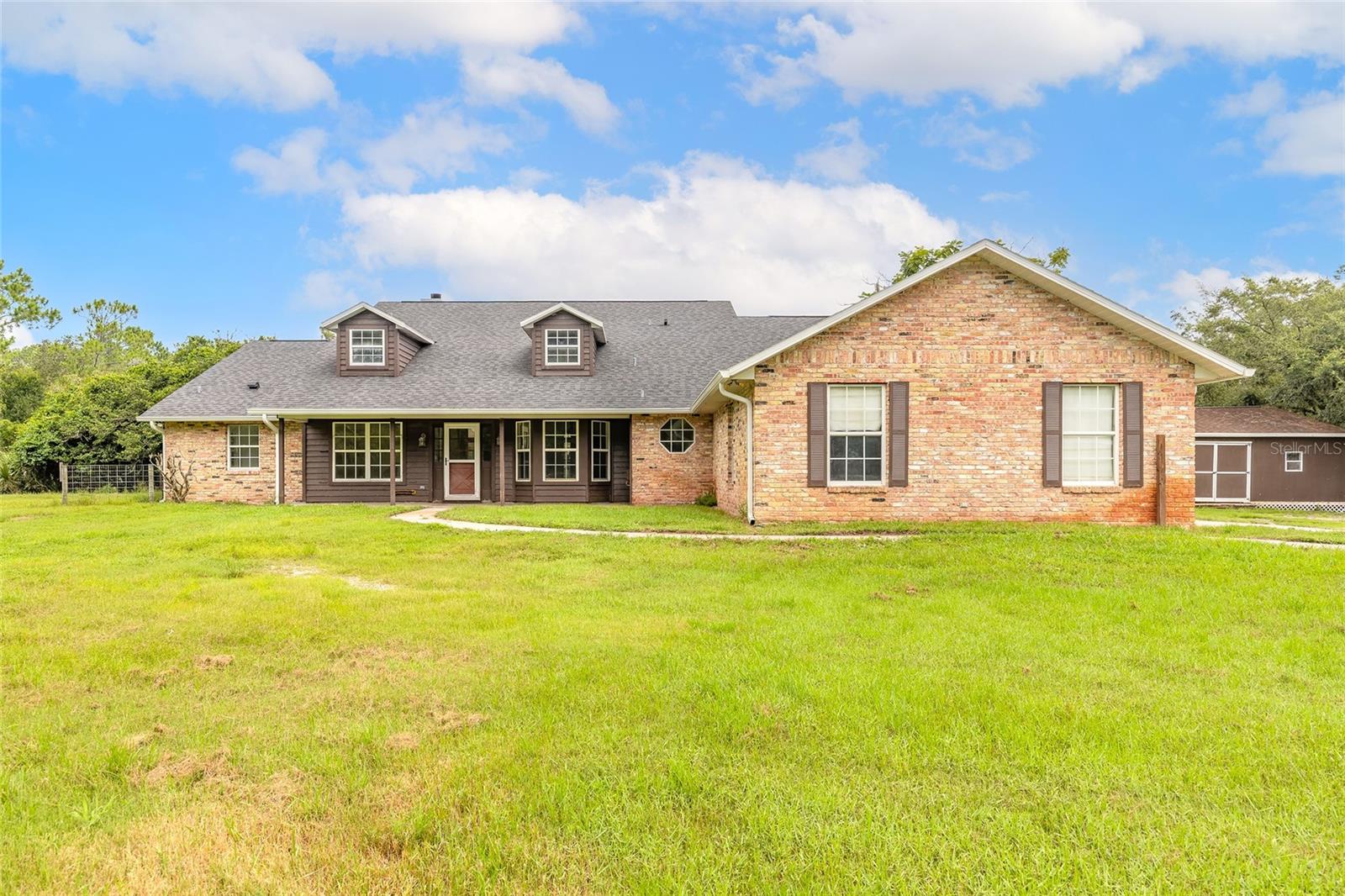 Equestrian home near the city and just minutes to the beach! This rare 5-acre property offers sought-after A-2 Rural Agriculture zoning—ideal for horse lovers, hobby farmers, or anyone seeking space and freedom. The sprawling 4-bedroom, pool home with a dedicated office boasts over 3,057 sqft of living space. Enjoy peace of mind with a newer roof, HVACs, pool pump, reverse osmosis water treatment system, and fresh paint. The property is fully fenced and cross-fenced with a 5 stall plus tack room barn, a 2 stall pole barn, and two storage buildings. Ample space for horses, trailers, RVs, boats, and all your toys. Whether you're raising animals, storing equipment, or just craving privacy close to town, this unique property has it all—rural living without sacrificing convenience!