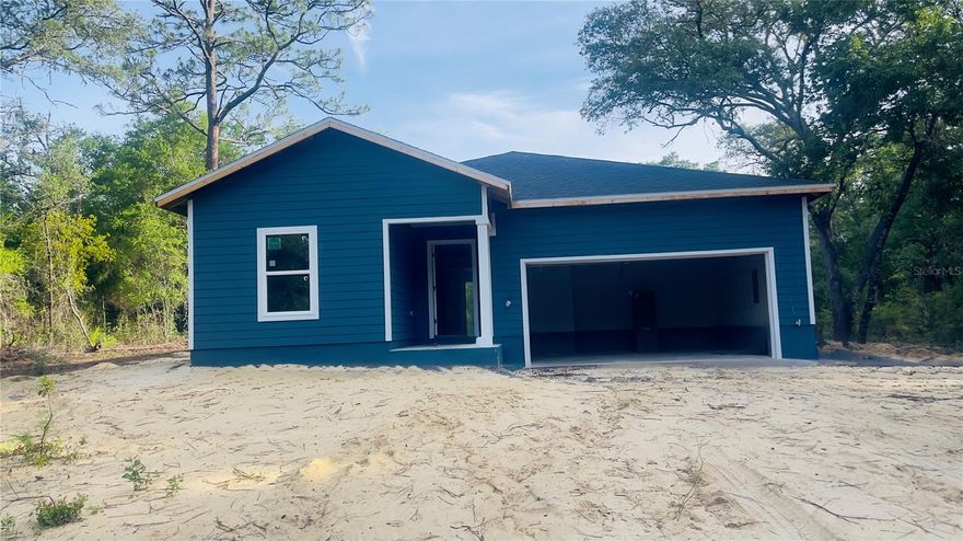 Under Construction. Interior photos are from a previous model and colors may be different. This cute & cozy 3 bedroom, 2 bath home sitting on a spacious 1.25 acre lot on paved county street offers quality craftsmanship with modern finishes. The interior features granite countertops, under-mount sinks, soft-close wood cabinetry, and a stainless-steel appliance package. Decorative tray ceilings with crown molding, luxury vinyl plank flooring throughout the main living areas, carpeted bedrooms, and updated fixtures contribute to the home's cohesive design. Large windows allow natural light to flow throughout the living spaces, creating a bright interior environment. The floor plan offers comfortable bedroom sizes and ample closet storage. Outside, the covered rear porch provides a place to enjoy the surrounding landscape, while mature trees offer shade across portions of the property. Plenty of space outside for animals, gardening, boat storage , etc. This brand new home offers a blend of thoughtful design, functional living space, and located just outside of the city limits. Short drive to schools, shopping, land local amenities while also being an easy commute to Gainesville or Ocala.
