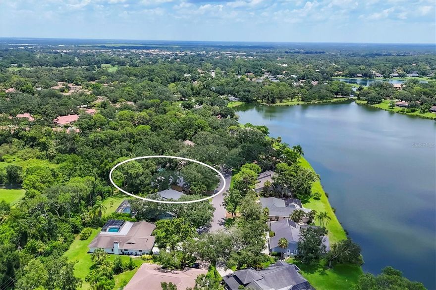 Rarely available and quietly set at the end of a cul-de-sac, this architecturally unique residence is surrounded by preserve views and lush landscaping on an oversized lot within the deed-restricted, gated golf course community of Bent Tree in Sarasota. A setting defined by privacy and peace, this home offers a true sense of serenity and uniqueness in one of Sarasota’s most prestigious zip codes. The scenic, tree-lined drive to the residence winds past Bent Tree’s majestic million-dollar homes, the lake and the gazebo, setting a tone of quiet elegance and natural beauty. The home itself is framed within live Oaks, hanging moss and orchids, with stone detailing and wood exterior trim lending warmth, texture, and timeless character. Inside, vaulted ceilings and skylights fill the rooms with soft natural light, enhancing the home’s zen-like atmosphere. Pocketing sliders to the 518-square-foot screened and covered lanai create effortless indoor-outdoor living and a constant connection to nature. Vintage bathrooms add authentic charm and individuality. The residence offers 3,566 square feet of living space under roof and 2,393 square feet of living space under air. The kitchen is the heart of the home and features a center island, custom cabinetry, and a built-in desk; and overlooks both the family room and serene natural backdrop. The Primary Suite is a private sanctuary, complete with two large walk-in closets, dual sinks with vanity, two linen closets, a walk-in shower and soaking tub, sliders to the lanai, and a fully fenced private outdoor sitting area. Two additional bedrooms, two full bathrooms, a powder bathroom, a 2-car garage and a laundry room complete the well-conceived single-level layout. The home is not located in a flood zone and benefits from a private well for irrigation. Outdoors, the property’s lush landscaping is an experience in itself, unfolding into an oasis of tropical serenity. Two massive islands anchor a lush retreat filled with mature plantings including areca palms, banana trees, bird of paradise, and live oaks with cascading moss—creating a sanctuary alive with butterflies and birds. Recent improvements include a new HVAC system (2025) and roof replacement (2021), offering peace of mind. With no CDD fees, low HOA fees, optional country club membership, and community lake access for small boats and fishing with permit, this residence offers a serene, natural lifestyle. Set within an A-rated school district, with the elementary school just a golf-cart ride away, the residence enjoys proximity to I-75, shopping, dining, Gulf beaches, and world class healthcare, while presenting a rare opportunity to buy into a gated million-dollar neighborhood at an attractive price point with meaningful move-up equity potential.  Lovingly owned by the same owner for 36 years, this is a property where architecture, landscape, and lifestyle converge. **Wallpaper has been removed since photography. See, fall in love, and make an offer.
