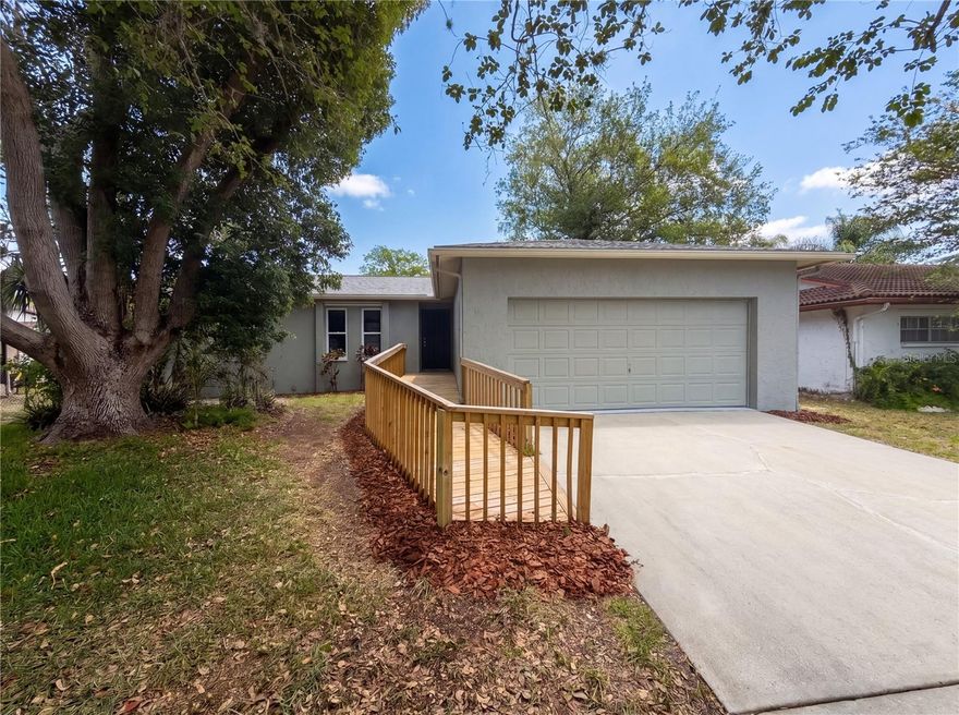One or more photo(s) has been virtually staged. Welcome home to this beautiful 3-bedroom, 2-bathroom, 2-car garage home located in the desirable
Meadows community of New Port Richey with NO HOA or CDD fees! From the moment you arrive, you’ll
appreciate the mature landscaping and inviting curb appeal. Step inside to discover a bright, open, and
airy floor plan featuring a neutral color palette that complements any décor style. The split-bedroom
layout provides added privacy, with the secondary bedrooms located on one side of the home and
sharing a beautifully appointed bathroom with a walk-in shower. The spacious kitchen is perfect for
everyday living and entertaining, offering granite countertops, ample cabinet storage, and a full
appliance package including a range, refrigerator, and dishwasher. Just off the kitchen, you’ll find a
dedicated dining area ideal for family meals and gatherings. The large family room provides plenty of
space to relax and enjoy peaceful pond views right from your living area. The generously sized primary
suite features an en-suite bathroom complete with a walk-in shower. A spacious laundry room
conveniently located near the garage adds additional functionality and storage space. Ideally located
close to Downtown New Port Richey and Sims Park, you’ll enjoy easy access to shopping, dining,
entertainment, live music, and community events. Don’t miss your opportunity to make this wonderful
home your own — schedule your private showing today!
