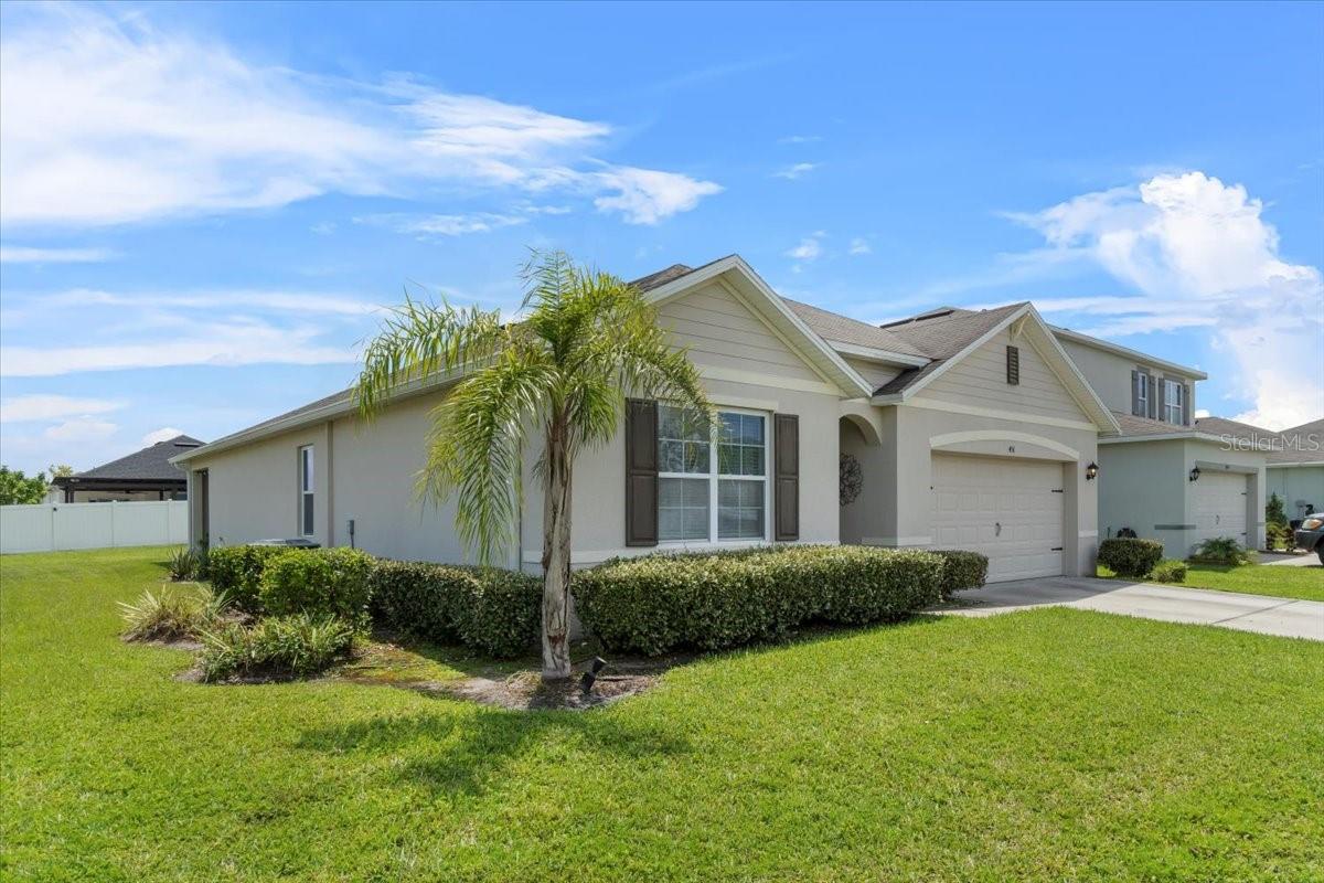 Welcome to your dream home in the highly sought-after Kindred community! This beautiful 4-bedroom, 2-bath residence sits proudly on a desirable corner lot, offering exceptional curb appeal and an abundance of yard space. Perfect for families, the property features mature fruit trees, a spacious covered patio for year-round outdoor enjoyment, and a 2-car garage with ample storage.
Step inside to an open-concept layout seamlessly connecting the kitchen, dining area, and family room—ideal for both daily living and entertaining. The kitchen boasts a spacious pantry, abundant cabinetry, and a functional flow for the home chef. Retreat to the generously sized bedrooms with large walk-in closets, while additional storage closets throughout the home keep everything organized.
Located just minutes from top-rated schools, dining, shopping, and major roadways, this home combines comfort, convenience, and community living. Enjoy all the amenities Kindred offers, from scenic walking trails to community pools and playgrounds.
Don’t miss the chance to own this exceptional home in one of Kissimmee’s most desirable neighborhoods—schedule your private showing today!