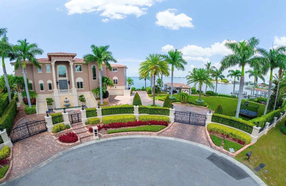 This magnificent estate on the tip of the Longfellow finger has all open bay views surrounding the entire property. The Home is 14,479 SqFt of land and can be purchased for $9,500,000. There is an adjacent lot being sold separately, but may also be added to the purchase of this home. (Please see the listing for the lot separately or get information from the listing agent T3438562). The home on lot 21 includes 5/6 bedrooms (depending on Buyer's use) with 7 full baths and 2 half baths. The ground level is 4,888 sq ft and has a large professional-type gym, a full pool/gym bath to the pool, and alternate dockage and dog park. The ground level also houses a game area, Chef's commercial kitchen, and a half bath. The 4-car is also adjacent to the house manager's office on the ground level. Although it houses a gym, storage, kitchen, gaming, baths, and HVAC it may not be insurable, and it is part of the breakaway walls and not included in the living square footage. The main living level (second floor) has a two-story grand entrance with separate living and dining rooms and an oversized family room with breakfast area, TV lounge area with small conversational seating space, and a huge open kitchen with state-of-the-art appliances. This entire area has views surrounding Open Bay as does every floor of the home. The butlers' station and wine cellar are between the kitchen and dining area. There is a bedroom/game area with bath and utility adjacent to kitchen. The main level also has a powder room, an enormous media room (family room style) with a bar and fabulous views that lead out to the large terrace. Even more, there is a guest ensuite adjacent to the media room. On the third floor living level there are four ensuite bedrooms. The master has phenomenal walk-in closets that span the entire Southside of the home. A large bedroom with living room and ensuite bath, similar in size to the master suite, is on the entire North side of the Estate. In the middle of the third floor are two more ensuite bedrooms, a sitting room, and a mahogany panel with a partner's desk. The viewing terrace spans from the master suite to the grand library/office. The grounds of the estate are fantastic with three docks and a very nice entertaining area- there is state of the art automatic electronics throughout the home and grounds. This property is minutes from the interstate, Crosstown, Downtown Tampa, International shopping malls, and airports (both private and public). It is less than 30 minutes to St. Pete beaches and 45 minutes to Clearwater and Belleair beaches, and an hour and 30 minutes to Disney. Appointment only and proof of funds are required.