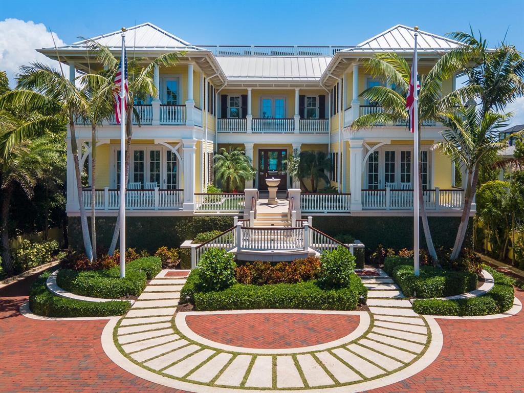 Under contract-accepting backup offers. The barrier island and enclave known as Casey Key offers some of the most exquisite residences along the Gulf Coast. Included in this portfolio of majestic gems includes Tweenwater, an estate aptly named as it rests between Sarasota’s Blackburn Bay and the Gulf of Mexico. From the early stages of its conception to the meticulous level of construction and finishes, not one detail was overlooked in creating this one-of-a-kind property. The entryway features a custom staircase inspired by the Harvard Club in New York City, while the formal living room is reminiscent of a true British West Indies home. For ease of entertaining, the spacious kitchen boasts ample cabinetry and flows perfectly into the dining and family rooms. A carefully curated selection of antique and new elements combines to create this exceptional residence, blending modern luxury with old-world charm. Designed to take advantage of the cross winds from beach to bay, the screened terraces transition seamlessly from the interior to the outdoors. Past the resort-like setting and infinity-edge pool await bayside boating and kayak lifts, along with 100 feet of private beachfront to the west. Rest, relax and soak up the sun or savor the endless views from the shade of a chickee hut. Fitness enthusiasts will relish the exercise, sauna, kayak and bicycle rooms. Designed by Herscoe Hajjar Architects and built by The Aerial Companies, this magnificent masterpiece provides seclusion and privacy, breathtaking beauty and luxurious quality that leaves a lasting impression. Architecturally sound, the concrete pile structure, masonry walls, Hardie Plank cement board siding, hurricane-rated windows and doors and Kynar metal roof were constructed to withstand the tests of Mother Nature, while the solar panel system utilizes energy efficiency. For peace of mind, the entire property is automated with a Crestron smart home system and Lutron lighting, integrated security and a fire detection system. An oversized 8 car climate-controlled garage and whole-house generator complete this impeccable piece of paradise.