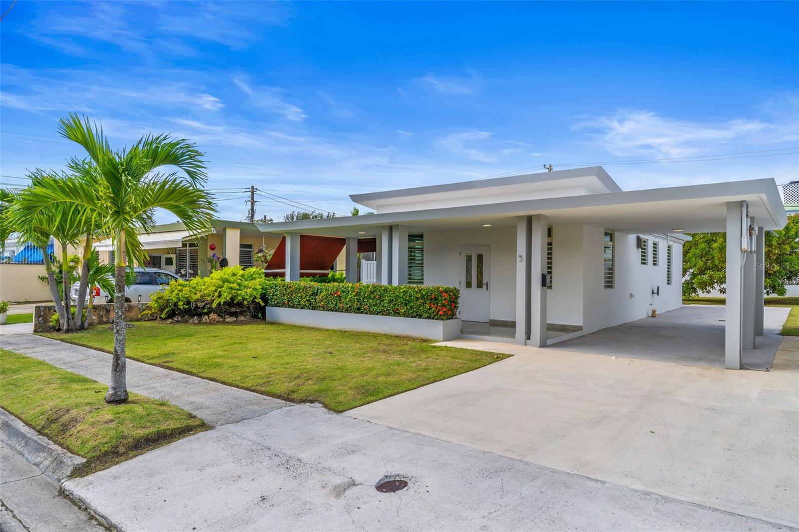 Spectacular single-story house in the secure and gated community of Villamar in Isla Verde, Carolina! Centrally located walking distance to the beach and just minutes away from the airport, with quick access to gas stations, bakerys, highways and main avenues. This beautiful home enjoys a private balcony and recently polished terrazo floors. It consists of 3 bedrooms, 1 remodeled full bathroom, a carport with parking space for up to four vehicles and a beautiful and spacious backyard. It comes fully equipped with stainless steel appliancces like refrigerator, stove with oven, microwave, washer/dryer combo, four ceiling fans and air conditioning inverter units in all bedrooms. It also includes a water cistern with pumping system. Dont let this opportunity pass and come live in one of the most desired, private communities near the coast of Carolina, Puerto Rico.
