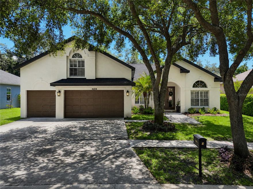 Truly one of a kind! Nestled in the heart of FishHawk Ranch in the quiet village of Merlin Glen and zoned for highly sought-after Bevis Elementary, Randall Middle, and Newsome High School, this stunning 4-bedroom, 3-bath home also features a private office/flex space (possible 5th bedroom), formal dining and living rooms, an oversized bonus room, a 3-car garage, and a sparkling screened-in pool and spa overlooking peaceful conservation views. From the moment you arrive, the curb appeal is undeniable, with fresh landscaping, a paver walkway, and a quiet tree-lined street welcoming you home. Step through the double front doors and immediately notice the beautiful LVP flooring, soaring ceilings with custom trim detailing, designer lighting, and extensive custom millwork that truly set this home apart.  Thoughtfully curated finishes, elegant feature walls, and custom built-ins throughout create a polished, model-like feel in every room. The office/flex room is anything but ordinary, featuring a beautifully designed custom Murphy bed with built-in lighting and shelving, creating the perfect guest retreat. Custom closet built-ins allow visitors to comfortably unpack and settle in for extended stays. Formal living and dining spaces are filled with character and craftsmanship, including custom built-ins, elegant millwork, crown molding, and a stunning architectural arch framing the sliding glass doors leading to the lanai. Designed with a desirable split-bedroom floor plan, the spacious primary suite is privately situated on one side of the home, while secondary bedrooms are thoughtfully placed on opposite sides for added privacy. The primary bedroom is a cozy sanctuary featuring beautiful trim work and mounted lighting, while the fully remodeled en suite bathroom offers a spa-like atmosphere with a freestanding soaking tub, separate walk-in shower showcased by tile all the way to the ceiling, and more designer finishes throughout. At the center of the home, the gourmet kitchen opens seamlessly to the family room and offers picturesque views of the fenced backyard and screened pool area. Gorgeous granite countertops and designer lighting showcase the 42-inch cabinets, newer Kitchen Aid stainless steel appliances, including gas range, and abundant prep and storage space. The heart of this home is the living room with vaulted ceilings, loads of natural light streaming in, and a custom feature wall with built-in fireplace and mantle. Upstairs, the enormous bonus room is ideal for movie nights, game days, or a playroom, and features stunning custom built-ins and media storage equipped with under cabinet lighting that add both style and functionality to the space. Every inch of this home reflects pride of ownership and attention to detail. More than move-in ready, this home is a true SHOWCASE. Every single room has been transformed. Recent updates and upgrades include:
• New roof
• New Exterior Paint
• ALL BATHROOMS REMODELED
• Updated kitchen 
• New interior and exterior lighting
• New pool pump
• Plantation shutters throughout
• Extensive millwork throughout
• Newer Kitchen Aid SS appliances
• Water softener
• 
Residents of FishHawk Ranch enjoy over 25 miles of walking and biking trails, resort-style community pools, pickleball and tennis courts, a skate park, playgrounds, fitness centers, and year-round community events — all with a warm, small-town neighborhood feel conveniently located near Tampa and Orlando.