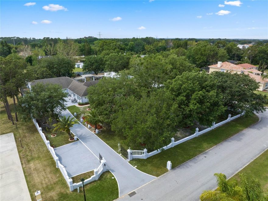 Looking for LAND and NO HOA, but want to be close to everything AND have excellent schools and easy access to all major highways?  This one is for you!!  Set on 1 ACRE of prime property in coveted Dr. Phillips sits this custom built home.  Featuring 4 large bedrooms and 4 full bathrooms, this POOL HOME has been meticulously cared for by the ORIGINAL OWNERS.  Renovated from top to bottom and potential for true MULTI-FAMILY LIVING this home offers so much more than you can find in any other home in the area.  Some of the amazing features include:  Private GATED Entrance, Concrete Wall Fence, huge updated Chef's Kitchen and an outdoor oasis that includes a private SWIMMING POOL and covered space perfect to create your own Summer Kitchen!  The oversized 4 CAR GARAGE offers over 1700 square feet with an upper level and separate entrance, primed to be the perfect IN-LAW SUITE, Gym, Office, you name it because the possibilities are endless!  Inside, the renovated kitchen is a chef's dream and includes DOUBLE ISLANDS, commercial size built-in refrigerator, DOUBLE OVENS, prep sink, ice maker, 3 built in microwaves, pot filler and large range.  A split bedroom plan offers space for everyone and is an ideal set up for entertaining and family living.   The primary bedroom has double closets, one so large it could be a nursery or office, and a spa like bath including a large soaking tub and shower system with a RAIN SHOWER and body jets!  Some additional features include:  Vaulted Ceilings, Crown Molding, Wood Floors, Porcelain Tile, Central Vacumn and Wood Burning Fireplace.  The extended driveway offers plenty of space for any and all the toys and cars you can imagine.  Windermere Heights is a well kept established neighborhood in the heart of Dr. Phillips in Southwest Orlando.  Be steps from award winning schools, Restaurant Row, Golf, Disney World, Universal (and the new Epic Universe) and Sea World.  Conveniently situated next to major highways you can be at the beach in an hour and MCO (Orlando International Airport) in 20-25 minutes.  Call today for a private tour.