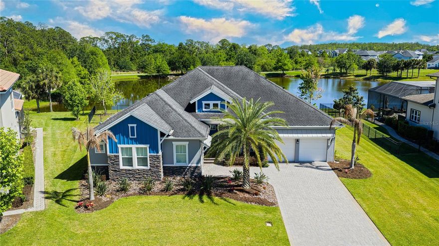 One or more photo(s) has been virtually staged. Located in the Manors—one of Laureate Park’s most sought-after areas with only 150 homes—this David Weekley pool residence sits on a prime .36-acre lot with 130 feet of lake frontage. Imagine magazine-quality sunrise views over water and conservation, and you’re here! This one-story home features 4 bedrooms, 4 full baths, and approximately 3,180 square feet of thoughtfully designed living space. The open floor plan, with banks of windows and high ceilings, creates a sense of spaciousness and quiet energy. The multiple tray ceilings and crown molding throughout set off the rooms with luxurious architectural detail.  Each main living area room has a real hardwood floor, and tile has been laid in the bathrooms. Ceiling fans and upgraded lighting fixtures are placed throughout the home, adding both comfort and style. The gourmet kitchen features top-of-the-line GE appliances, including a gas cooktop, range hood, built-in convection oven, and microwave, along with stone countertops and ample storage. Additional features include a first-floor primary suite, walk-in closets, and wet and dry bar areas ideal for entertaining. Step outside to a sweeping waterfront vista–the finest view in the neighborhood! A covered back patio with an outdoor kitchen leads to the custom pool and a soothing natural-rock waterfall. A 3-car garage(Single & Double) with large motor court driveway, natural gas, ENERGY STAR windows, and an in-wall pest system complete the home. In Laureate Park, community life is the perfect blend of nature, activity, and entertainment. Residents can enjoy the aquatic center, which features lap pools, sand volleyball, hammocks, and a children’s water park. Venture out to zipline, bike, walk, or just relax at the community’s parks and on its trails. Any day of the week, enjoy Lake Nona Town Center with its many dining and entertainment options! 13221 Lower Harden Ave in Laureate Park is an unusual find, and it won’t stay on the market for long. Call today!