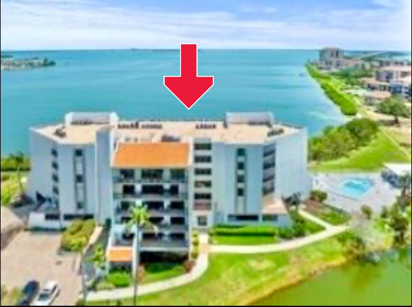 Unobstructed views of Tampa Bay & Sunshine Skyway Bridge from every room in this 3rd-floor 2BR/2BA condo in Vista de Oro at Playa Escondida, Isla del Sol’s premier waterfront community! From the moment you open the door, you are greeted with breathtaking panoramic vistas, a natural sanctuary with daily dolphins and manatee sightings. Spacious kitchen with eat-in area—spotless yet retro—ideal for a modern remodel. Pass-through window could easily open to a breakfast bar or island. Expansive living/dining area opens to a rare wraparound balcony spanning both bedrooms, perfect for entertaining. The split floor plan provides privacy with the primary suite featuring oversized walk-in closet, spacious original separate vanities, generous walk-in shower, and sweeping Tampa Bay views directly from your bed. Guest suite includes dual closets, full bath, and another wall to wall sliding door with balcony access. Laundry closet is conveniently located by the kitchen, new water heater, HVAC (2023). Assigned under-building covered parking plus guest parking. The community features resort-style amenities: new waterside pool with hot tub, gazebo, and private beach. Perfect location if you decide to join the Isla Del Sol Yacht and Country Club and their golf course membership. Just 10 min to downtown St. Pete, 30 min to Tampa Int’l, close to Fort De Soto beaches. Quick elevator ride to your own private beach. Rare opportunity to create your dream waterfront home with the best views in Isla del Sol.