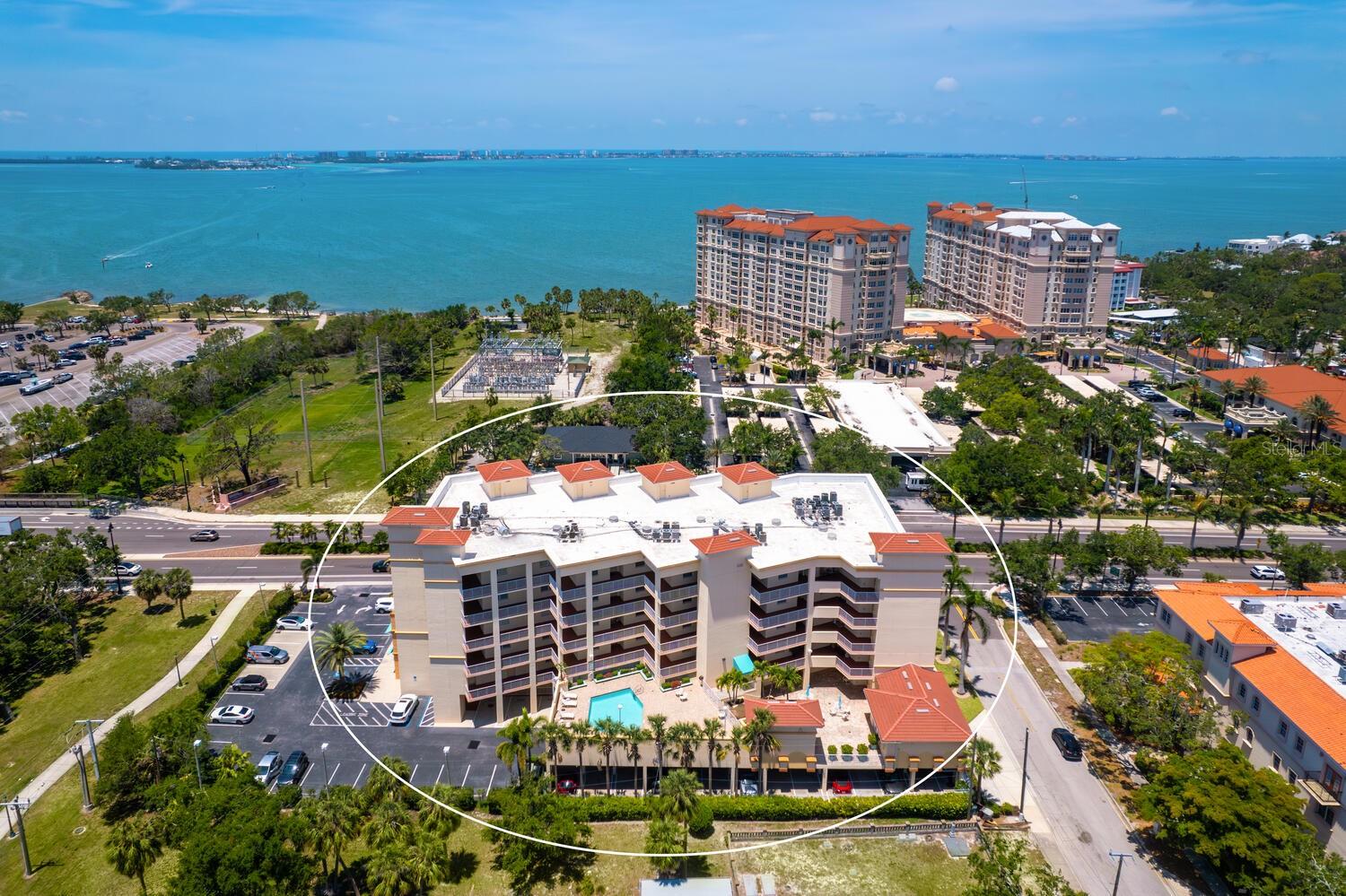 Welcome to this beautifully designed 3-bedroom, 2.5-bath condo offering 2,020 square feet of spacious, light-filled space in one of Sarasota’s most desirable locations. This elegant end-unit lives like a single-family home and captures the essence of vibrant city living. Step into a gracious foyer with a built-in cushioned bench—perfect for greeting guests in style. The expansive living and dining area features two sets of sliding doors that open to a large private terrace where you’ll enjoy stunning sunsets, partial bay views, and twinkling city lights in the evening. It’s the ideal setting for relaxing or entertaining, seamlessly blending indoor and outdoor living. The open kitchen boasts wood cabinetry, granite countertops, a breakfast bar, and a closet pantry, perfect for everything from casual meals to festive gatherings. The owner’s suite is a serene retreat with terrace access, two walk-in closets, and a luxurious bath. The second bedroom, with double-door entry, is currently used as a home office with a half bath conveniently located across the hall. The third bedroom includes its own walk-in closet and full bath, offering a private space for guests with a hallway pocket door for added privacy. This home also features impact-rated windows throughout and two secure, assigned parking spaces on the ground floor. San Marco amenities include a heated pool, fitness room, sauna, secure entry, and a pet-friendly environment. Step outside and stroll to The Bay Park, Sarasota’s new 53-acre signature waterfront park offering trails, events, and natural beauty. Enjoy the convenience of nearby restaurants, grocery stores, and downtown Sarasota’s vibrant shopping, dining, arts, and cultural scene. You're also just minutes from the Ringling Museum, Lido Key, St. Armands Circle, and easy access to world-class theater, symphony, opera, ballet, and more. This is Sarasota living at its finest—where everyday life feels like a front-row seat to the best of culture, coast, and community.