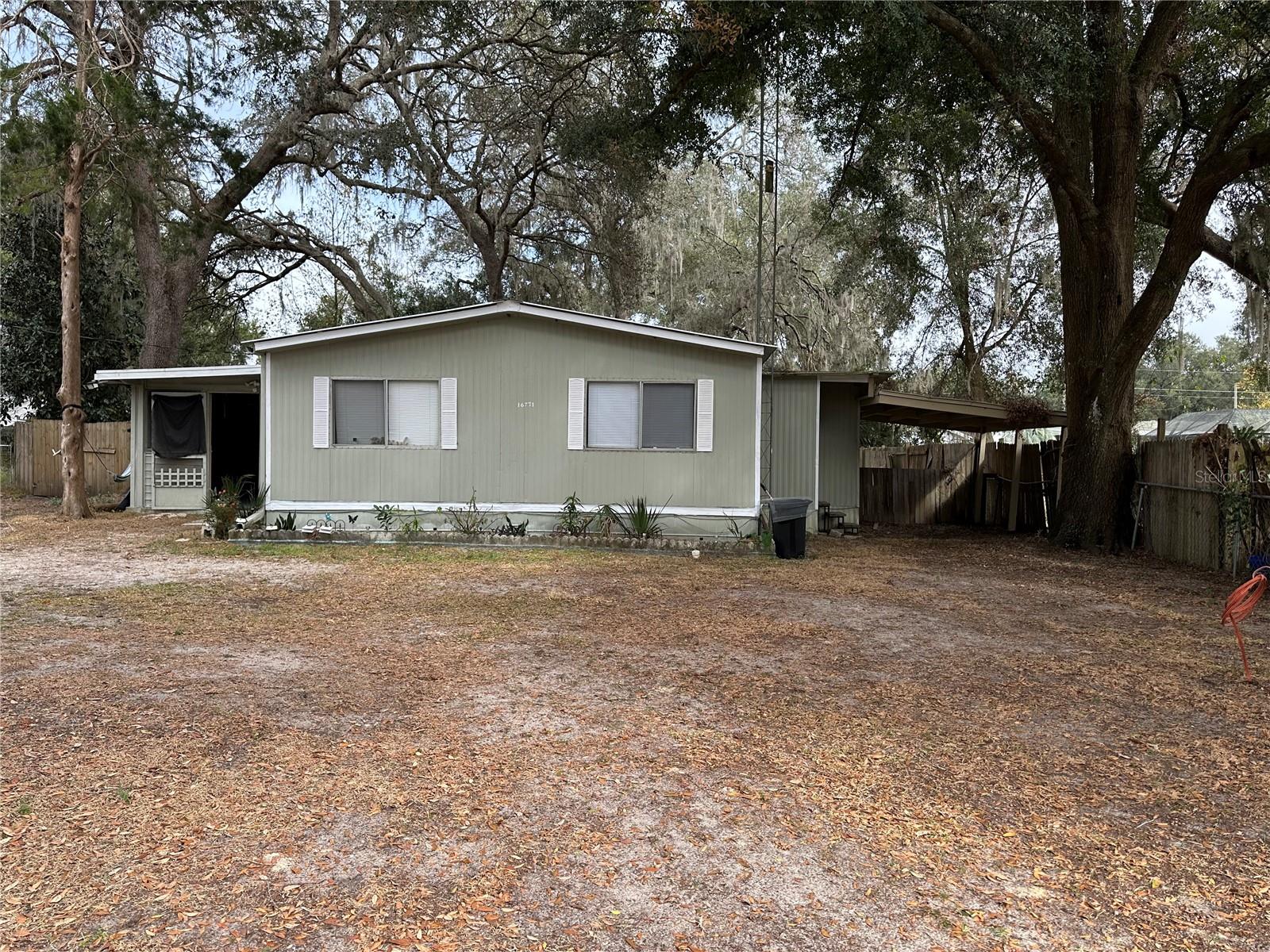 Affordable home...ready to move in with open floor plan, two bedroom two bath, with a den/bonus room on .22 acres in a private community close to The Villages Florida. Enjoy your own retreat with private fenced back yard with a storage/work shop, large backyard for your four-legged friends to run free. NO HOA! Indoor laundry facilities and carport. Make this your own home by adding your own personal touches allowing you to RELAX with the many activities close by to The Villages with nightly entertainment at Spanish Springs Town Center, only minutes away along with many restaurants, shopping, doctors offices and local business. Easy access to Ocala and Leesburg. This could be a great income producing property for those investors looking to be landlords. Come and see it for yourself!