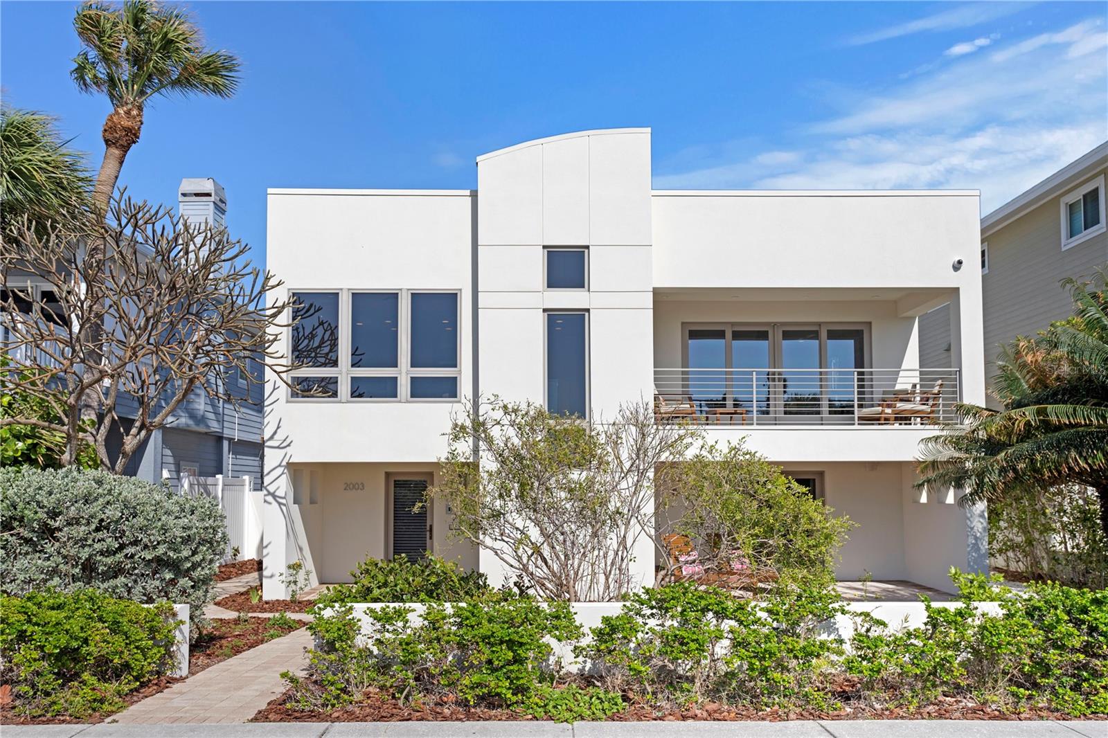 Modern Gulf-View Masterpiece | 4 Bed, 4 Bath | Custom Luxury Finishes. This contemporary architectural gem offers breathtaking, unobstructed Gulf views and is move-in ready. Renovated in 2013, the home features approximately 2,350 sq. ft. of light-filled living space upstairs, with an additional 1,600 sq. ft. on the lower level. Designed for elevated coastal living, this 4-bedroom, 4-bath residence includes a private elevator, smart home automation, and two-zone HVAC for maximum comfort. Upper-level HVAC has UV Air Purification. The open-concept main living area features wide-plank oak flooring, while all bathrooms are beautifully tiled. The chef’s dream kitchen boasts a custom gourmet setup, including: • Viking 6-burner natural gas range with electric oven • Built-in Liebherr refrigerator • Miele dishwasher with panel matching cabinetry • Wolf built-in steam convection oven, warming drawer, and microwave • Quartz countertops The luxurious primary suite offers a spacious walk-in closet and rich dark oak flooring complemented by powered window blinds for modern convenience. Step out onto a private outdoor tile deck, perfect for morning coffee or evening relaxation. Additional amenities include laundry room, an entertainment bar area as well as a media room equipped with a 75” Sony TV and surround sound. Built for durability and peace of mind, the home features Pella and Andersen hurricane-resistant windows and sliding doors. Sprinkler system pump replaced, and all sprinklers inspected and operating 2025. The oversized garage accommodates up to two vehicles. Roof is Rolled Modified Bitumen. Flood elevation is 9 feet. Bonus: Potential for a third-floor roof deck addition to expand outdoor living and take in panoramic Gulf views.