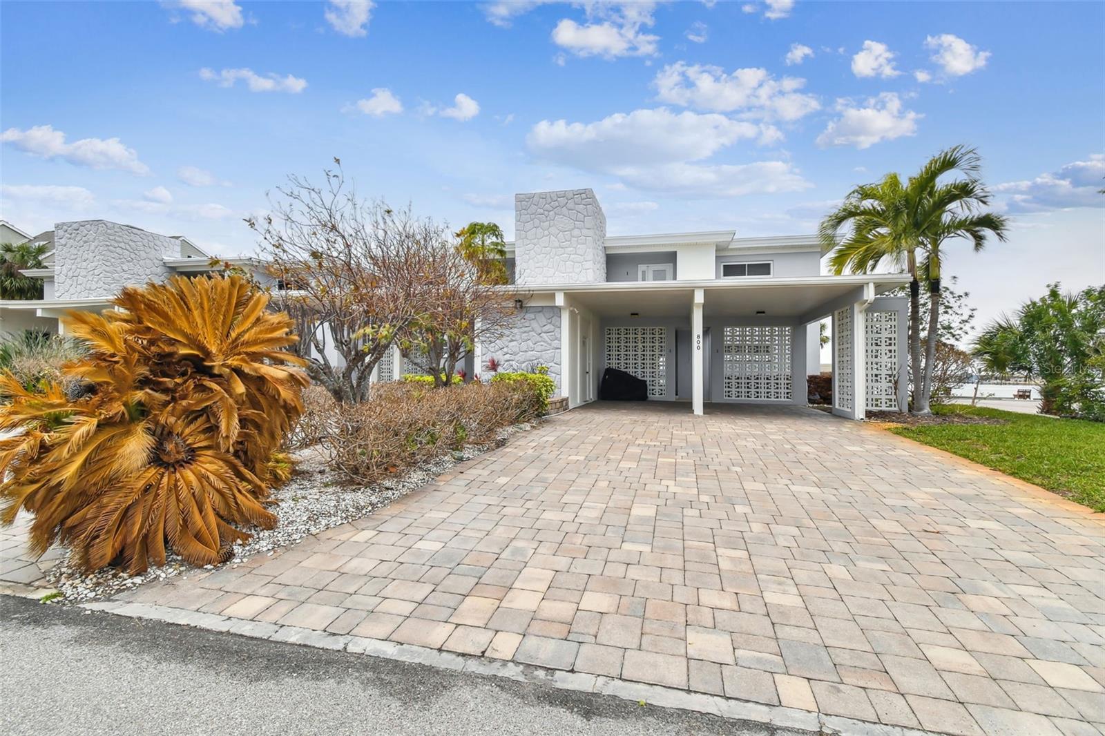 Discover your slice of paradise with this stunning first-floor condo in the sought-after Tierra Verde community, offering serene views of the Pass-A-Grille Channel. This 2-bedroom, 2-bathroom home is a rare find, boasting a perfect blend of modern upgrades and coastal charm. The home features updated kitchen and bathrooms with contemporary finishes and all-tile flooring for easy maintenance and a clean, modern look. A new AC system and newer hot water heater provide peace of mind, while new roofs are currently being installed on both buildings. The rear porch is a standout feature, with a custom commercial-grade glass enclosure built to withstand Florida’s unpredictable weather. The community association will also be enhancing the property with new and improved landscaping, creating an even more inviting atmosphere. Buyers can move in with peace of mind, as the seller will cover the special assessment for these improvements. This condo did not experience flooding during recent hurricanes, offering additional assurance in this prime location. Enjoy the tranquility of a boutique-style community, where you can relax and take in stunning waterfront views or embrace the vibrant Tierra Verde lifestyle, with nearby beaches, dining, and outdoor activities. Whether you're looking for a full-time residence or a vacation getaway, this condo is your perfect retreat. Don’t miss this unique opportunity—schedule your private showing today!