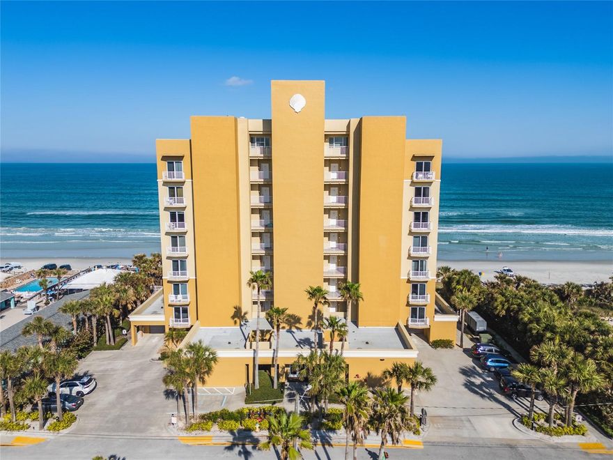 One or more photo(s) has been virtually staged. Direct oceanfront living awaits in this rare end-unit residence at The Malibu in beautiful New Smyrna Beach located on the desirable 7th floor. Perfectly positioned just south of Flagler Avenue, this boutique 29-unit community offers unobstructed Atlantic views and an exceptional coastal lifestyle. This spacious 3-bedroom, 3-bath condo boasts 2,226 square feet of light-filled living space with an open floor plan designed to capture stunning ocean vistas. As a highly desirable end-unit, enjoy additional windows that flood the home with natural light. The well-appointed kitchen features wood cabinetry, granite countertops, stainless steel appliances, and a large walk-in pantry—ideal for both everyday living and entertaining. The primary suite serves as a private retreat with direct ocean views, a generous walk-in closet, and a spa-inspired bathroom complete with soaking tub, dual vanities, walk-in shower, and enclosed water closet. A split-bedroom layout offers privacy with a second en-suite at the front, plus a third bedroom and guest bath. Recent updates include: new A/C unit 2023 and new hot water heater 2020. Additional highlights include a formal dining room/flex room, spacious interior laundry room, and owner’s storage closet. Step outside to two private balconies, including an expansive rear balcony where you can enjoy breathtaking sunrises over the Atlantic Ocean. This residence is offered fully furnished for immediate enjoyment or investment opportunity. The Malibu is a well-maintained community with impressive recent upgrades, including new exterior paint (2024), remodeled lobby (2022), updated seawall with 60-ft extension, and a newly enhanced pool, spa, and paver deck. Residents enjoy a heated pool (seasonal), clubhouse with fitness center, garage parking, elevator generator, and pet-friendly ownership. Weekly rentals (7-day minimum) offer excellent flexibility. Experience the best of beachfront living in one of New Smyrna Beach’s most sought-after boutique communities—schedule your private showing today.