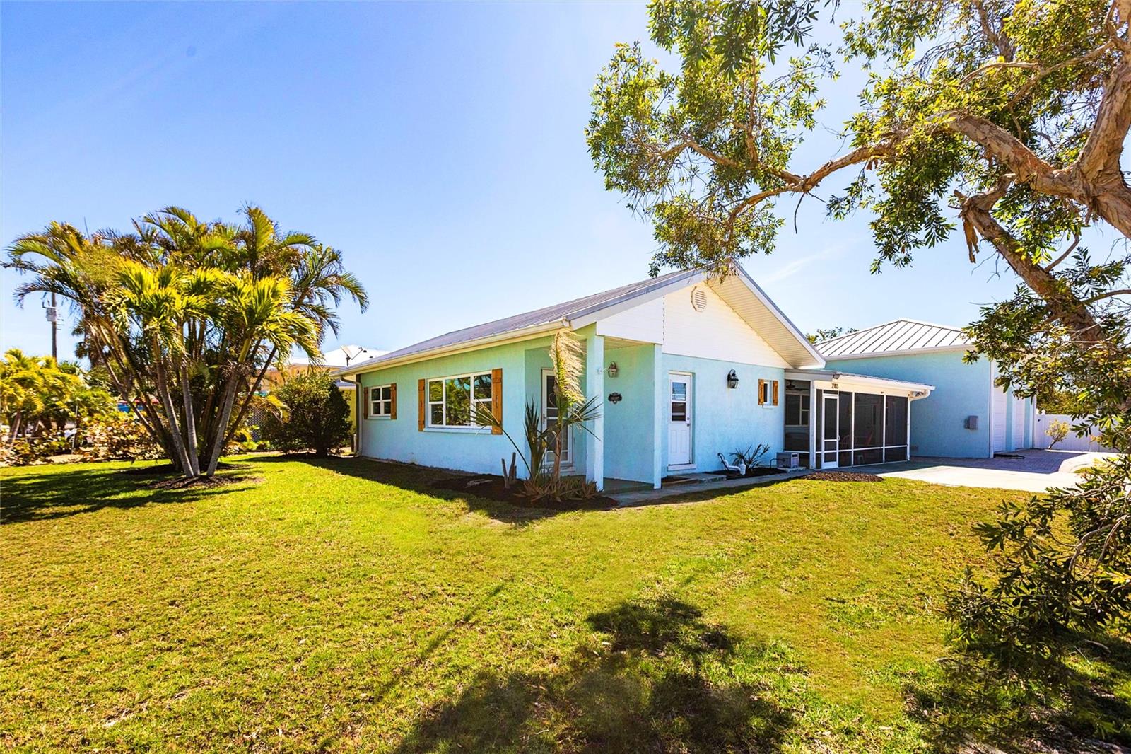 One or more photo(s) has been virtually staged. $50,000 price reduction, ACT FAST! Anna Maria Island life is waiting for you! Move in ready, just underwent major remodel! This bright and airy, three bedroom pool home is a short stroll to the world class beaches of Anna Maria Island. Master bedroom features huge walk in closet and master bath. Sliding doors from master bedroom lead you right out to your tropical, private, backyard with pool. This home was immediately remediated after hurricane damage. The rebuild features new shaker cabinets with light and bright quartz countertops, five inch base molding, paint, and interior doors. Other features include large, screened lanai with morning shade, metal roof and impact windows. For you hobbyists, or car enthusiasts, there is also a separate 600+ sq. ft. monster garage! This garage has its own subpanel, paved driveway, two separate garage doors, storage area, rv electrical hook-up AND is tall enough for a car lift! Large 8,999 square foot lot with plenty of southern exposure. RV and boat parking allowed. Nothing to do here but relax and enjoy the beach, dining, listen to the parrots flying overhead, and watch the manatees and dolphins playing in the canal across the street. Located on quiet dead end street right in the Island's sweet spot between Cortez and Manatee Bridges. This ideal location features easy access on and off the island. Just a short stroll, or golf cart ride to the white sandy beaches, restaurants, shops and convenient free trolley stop. Immerse yourself in all the serenity and joys this beautiful island and home have to offer!