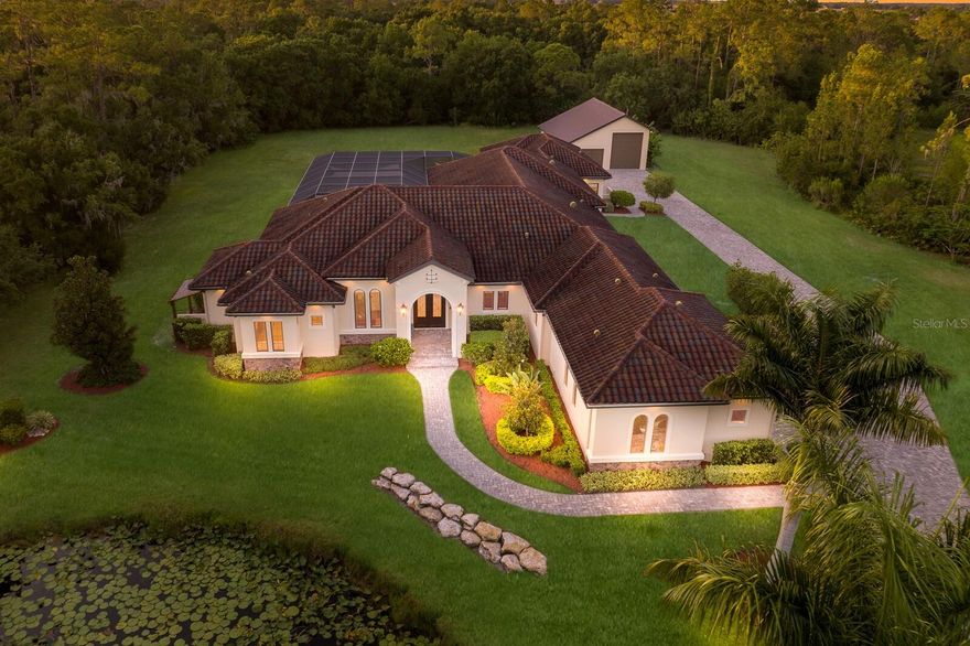 RARELY AVAILABLE, CUSTOM FAMILY COMPOUND IN THE HIGHLY RATED EQUESTRIAN COMMUNITY OF BRIDLE CREEK AT PANTHER RIDGE!  Nestled within this unspoiled, natural and private setting you’ll find this amazing custom residence built by local premier homebuilder, Kemick Builders, renowned for fully customized homes with the epitome of energy efficient, environmentally sustainable and structurally superior features. The home is positioned on 8.36 acres on a very private cul-de-sac with lush Florida vegetation, protected woodlands and over 15 miles of hiking and equestrian trails.  At the entry you’ll note the 11’ double iron doors with oil-rubbed bronze and Low E double-paned glass. 14’ ceilings greet you as you notice the beautiful Travertine flooring throughout the main living areas.  Energy efficient features include PGT hurricane rated, insulated, low E, SolarBan impact windows and 10’ sliding doors, Icynene insulation in the main and guest homes plus the extra garage in the RV barn, a dedicated transformer, a 20kw Kohler generator, a whole-house water filtration system, LED lighting, a tankless water heater with recirculation, 1,000-gallon owned (not leased) underground propane tank, and separate AC and de-humidification systems for both residences and barn garage.  Unique and exceptional features of this home include a beautifully functional, 2-bedroom, 2-bath guest house (kitchen, washer and dryer, dedicated AC and de-humidifier) adjoined to the main house by 720 sq/ft of covered seating and BBQ area that opens to an amazing 2,700 sq/ft lanai.  The expansive pool is 50’x20’ and includes a sun shelf with bubblers, huge Jacuzzi hot tub with waterfall, shade-sails and Shellock paver decking. The BBQ lounge features remote-controlled SPF electronic screens with dedicated air-conditioning for the space. The home also includes a fantastic Movie Theater with BAT insulation for sound deadening, an 86” screen with ultra-premium sound system, two rows of leather reclining theater seating with LED lighting and granite bar area with built-in cabinetry.  Of note as well is the Clare Home Automation System including 8 security cameras, 4 keypads, 10 data outlets and wireless extenders.  The master suite includes a massive closet built as a “safe room” constructed with 6-8” of reinforced concrete and Security/Vault door.  Also, rarely found (in addition to the 3-car garage with epoxy floors) is a separate RV Barn with additional working garage! This building includes a 15’x46’ RV parking garage with a 50A outlet,14’ door and connecting doors to the 16’x46’ working garage, which is Icynene insulated, air-conditioned and includes multiple power and lighting options for a workshop or collector car care.  This structure is the second of three that are allowed on the property, allowing you the option of adding a horse barn or guest house.  Unrivaled privacy, a serene natural setting and the ultimate in a luxury residence combine in this amazing property, all minutes from the Nation’s Top Master Planned development of Lakewood Ranch, and all the world-class features and conveniences that provides.  Plus, don’t forget you’re a short drive from the world’s top beaches, shopping, dining and entertainment of Sarasota, Bradenton, Tampa and Naples.  This is a rare offering with the perfect combination of tranquility and privacy with an amazing luxury residence and close proximity to some of the nation’s top destinations and attractions.  Don’t miss this opportunity!