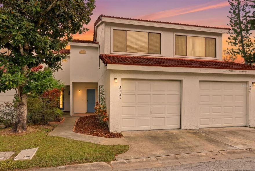UNBEATABLE LOCATION. NO COMPROMISES. FULL STOP. Just a little over a mile from Universal Studios Florida, this updated 2-bedroom, 2.5-bath condo with a 1-car garage drops you right into the heart of everything that makes Orlando electric without sacrificing comfort, privacy, or livability. Inside, it hits immediately. New flooring, 5” baseboards throughout, high ceilings, and tons of natural light set a clean, modern tone that feels intentional and effortless. The main level flows straight into an updated kitchen with crisp cabinetry, stainless steel appliances, and a breakfast bar that works just as well for everyday living as it does for hosting. Slide open the doors and you’re out on a covered back porch with private fencing—a rare, true outdoor extension you don’t usually get with a condo. Upstairs, both bedrooms are spacious and filled with light. The primary suite delivers with a large walk-in closet featuring custom built-in shelving and a beautifully renovated en-suite bath showcasing a statement shower and updated flooring. The guest bathroom keeps pace with classic subway tile and a sleek glass shower door, giving the entire home a polished, move-in-ready finish. Located in Marbella Woods, you get low-maintenance living done right—with a community pool and an association that handles exterior maintenance, roof, and grounds, so your time stays yours. And the location? This is where it separates itself. Minutes from Restaurant Row, Dr. Phillips Marketplace, and the Mall at Millenia, plus easy access to major highways for commuting and travel — this is one of Orlando’s most in-demand corridors, period. Zoned for Dr. Phillips High School (Go Panthers!), this property checks every box—whether you’re buying to live in and hold long-term, or secure a high-demand rental in a location that does the heavy lifting and never cools off. This isn’t just a condo.?It’s leverage. It’s location. It’s Orlando — from the front row.