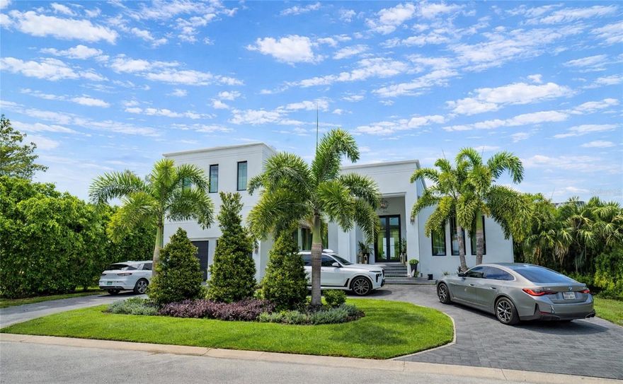 This design-forward South Tampa waterfront home delivers modern luxury, architectural intention, and resort-style living in one of South Tampa’s most desirable boating neighborhoods. Completed in 2023, this custom waterfront residence sits on an expansive 82’ x 123’ lot with west-facing sunset views. Mabry, Coleman, Plant school district.

A striking arrival begins with a double herringbone paver circular driveway, leading to a clean, contemporary façade that immediately sets this home apart from traditional South Tampa construction. Inside, large-format marble floors, volume ceilings, and refined molding details create sophistication throughout. 

The thoughtfully designed open floor plan balances elegance and functionality, ideal for both everyday living and entertaining. A formal living room and custom bar anchor the front of the home, while the rear opens to a spacious great room overlooking the water. Custom solid-wood cabinetry and marble countertops with refined edge detailing and profiles appear throughout, a level of craftsmanship found only in true luxury custom homes.

The chef’s kitchen is a standout, featuring a 48” gas range, 36” Sub-Zero column refrigerator, 30” Sub-Zero freezer, Scotsman ice machine and extensive custom cabinetry designed specifically for this residence. The kitchen flows seamlessly into the main living space, making it ideal for entertaining and waterfront living.

All bathrooms are finished entirely in marble, thoughtfully combining large-format marble slabs with custom marble mosaics to create a layered, high-end spa aesthetic. A dedicated pool bath is conveniently accessed from the outdoor entertaining area, an often-overlooked luxury that allows guests to move effortlessly between indoor and outdoor spaces during gatherings.

The home offers four bedrooms, including a primary suite on the main level and a downstairs guest suite, ideal for multigenerational living. Upstairs, two additional ensuite bedrooms provide privacy and flexibility. Every closet throughout the home features custom built-in systems, maximizing both storage and design continuity.

Indoor and outdoor living are seamlessly connected through a dramatic 20’ wide x 10’ tall glass pocketing slider, opening to an expansive covered lanai. The outdoor living space rivals a private resort, complete with outdoor dining, multiple lounge areas, a full stainless-steel outdoor kitchen, built-in grill, outdoor refrigerator, and a custom pizza oven, all overlooking the water.

The waterfront infrastructure is equally impressive, featuring a new seawall, new dock, and a boat lift capable of accommodating a 31’ boat, making this an exceptional opportunity for boating enthusiasts seeking deep-water access in South Tampa.

Furnishings are available for purchase, having been professionally selected and designed specifically for the home.

This is not a typical waterfront listing. It is a luxury South Tampa waterfront home designed for buyers seeking newer construction, high-end finishes, boating access, and a true indoor–outdoor lifestyle.