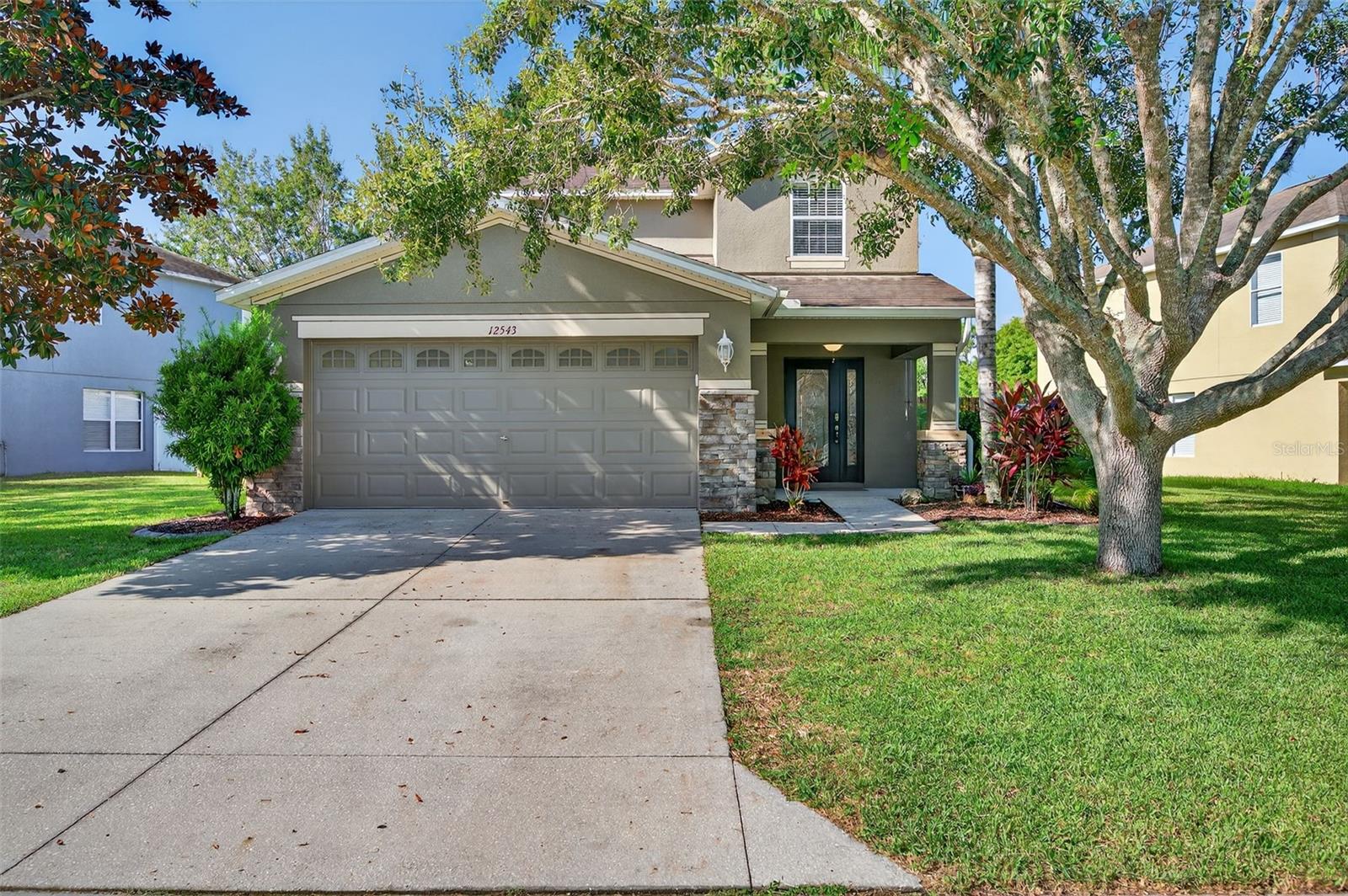 Welcome to this beautifully maintained 5-BEDROOM, 2.5-BATH home in the highly sought-after GATED COMMUNITY of The Verandahs. Offering 2,180 sq. ft. of living space, this home features a spacious and functional layout designed for comfort and convenience. The PRIMARY SUITE IS LOCATED DOWNSTAIRS and includes a COMPLETELY UPDATED EN SUITE BATHROOM with modern finishes. The kitchen has been fully renovated with QUARTZ COUNTERTOPS, wood cabinetry with pull-outs, and updated appliances, making it both stylish and practical. Upstairs, you will find a SPACIOUS LOFT / BONUS ROOM, 4 well-sized bedrooms, and a full bathroom with shower / tub combo and linen closet. Having these extra bedrooms provides ample space for guests or even a home office, and the floor plan is open and inviting, creating the perfect setting for everyday living and entertaining. Outside, the property sits on a BEAUTIFUL POND lot with a FENCED BACKYARD. A large SCREENED-IN PATIO extends your living space outdoors, while an adorable WOODEN TREEHOUSE PLAYGROUND adds a fun area for the little ones to play! The home is also situated on a quiet DEAD-END ROAD, providing added safety and security. Residents of The Verandahs enjoy access to a COMMUNITY POOL, PLAYGROUND, & FITNESS ROOM and the peace of mind that comes with living in a gated neighborhood. Conveniently located just 3 miles from the Suncoast Parkway, this home offers easy access to Tampa International Airport, restaurants, shopping, and more! Call today for your private showing!
