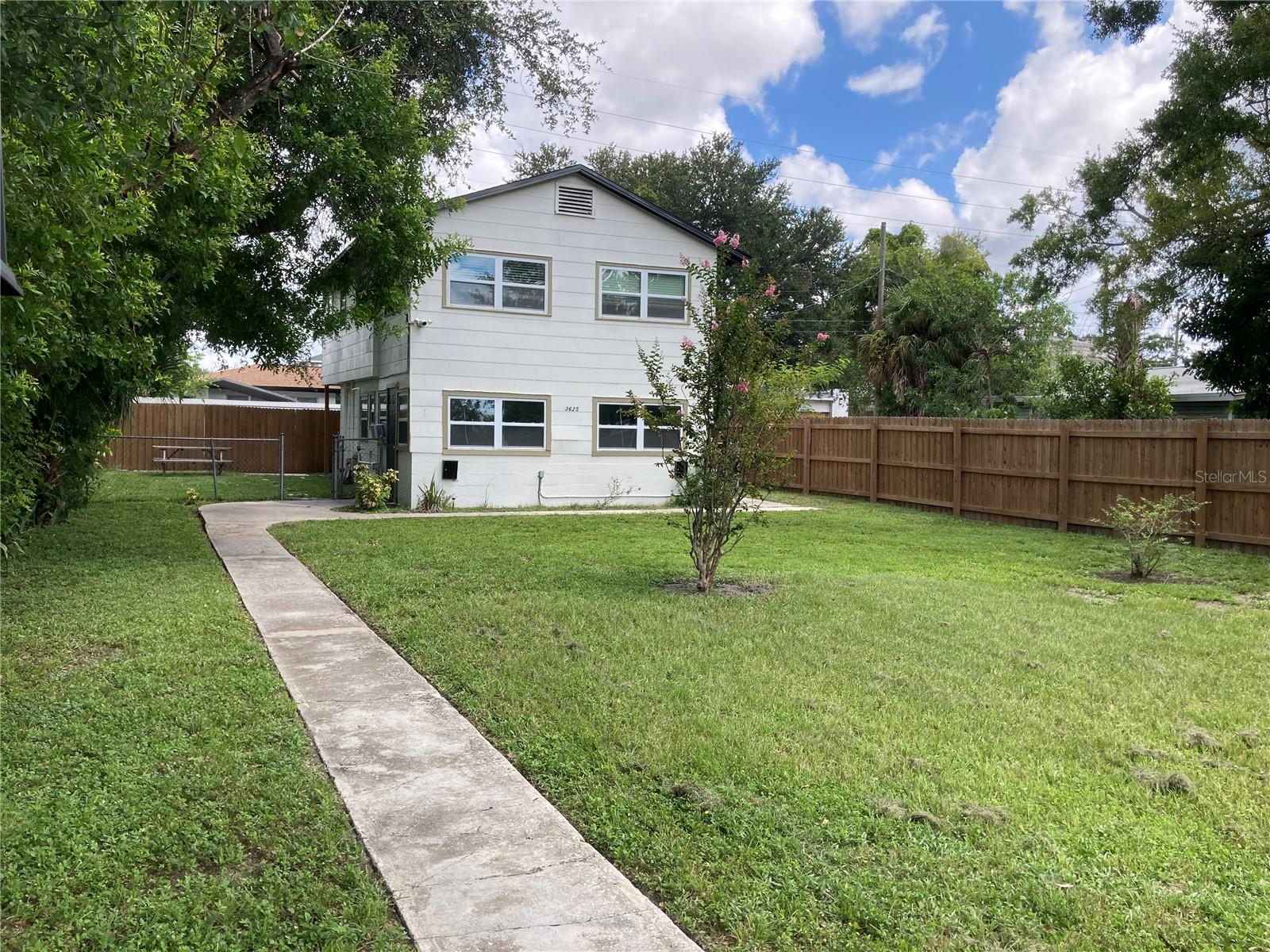 Private garden-style 2/1 apartment surrounded by mature trees, large lawn and flowers. Located in quiet neighborhood on a classic brick street. This property is being offered partially furnished for a seven month lease. This oasis of serenity is the second floor unit of a duplex. The unit has new mini splits, new kitchen, decorative fireplace and new hurricane impact windows. In unit laundry with very small washer/dryer combo for convenience only. Microwave for convenience only. Shared fenced yard.Two small pets considered. $300 Non-Refundable Pet Fee Per Pet. All animals must be approved through petscreening website. The duplex is 2 blocks from Central Ave and minutes from all of the downtown St. Pete highlights.