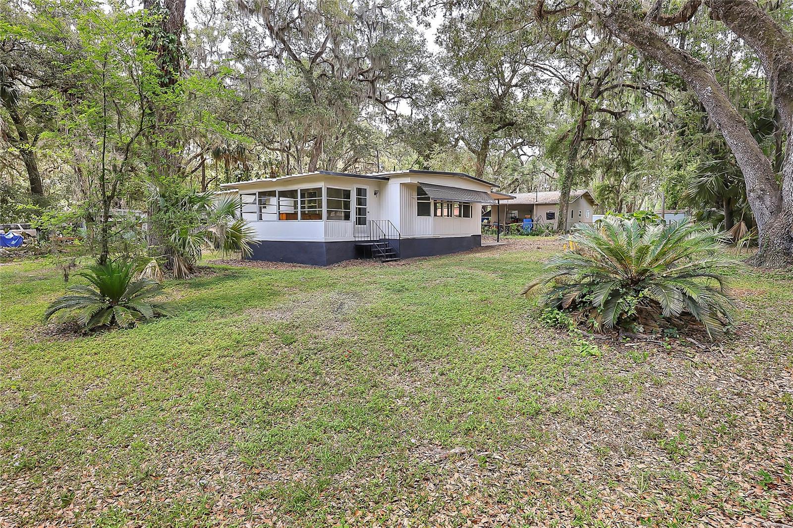 Refreshed and move-in ready! This charming mobile home at 3617 County Road 406 sits on a spacious corner lot with no HOA, and best of all — you own the land. Inside, enjoy new flooring and carpet throughout. Outside, the property features a carport for covered parking and a shed for extra storage. Located in peaceful Lake Panasoffkee, this home is perfect as a full-time residence or a weekend retreat. Don’t miss this affordable Florida gem!