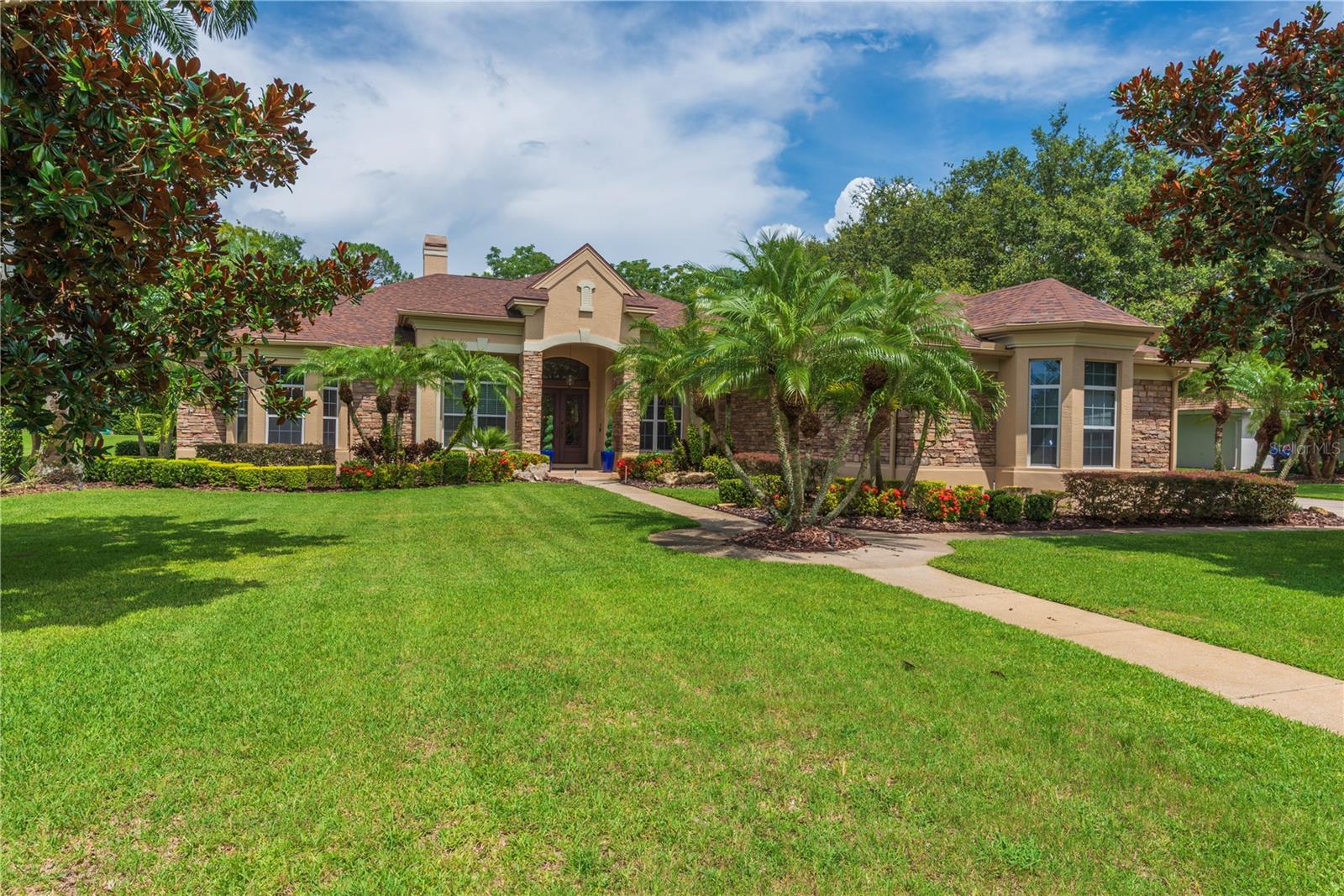 Step inside this beautifully cared-for Rutenberg stunner in Cypress Lakes Estates — where refined elegance meets laid-back luxury. Sitting pretty on a lush, private .75-acre lot, this one-story pool home has everything: 4 bedrooms, 4 full bathrooms, a dedicated office, a bonus room made for fun, and a 3-car garage — all wrapped in swaying trees and lush landscaping like a quiet little secret tucked near East Lake High.
Enter through impact-rated double doors and feel the openness hit you: soaring ceilings, classic moldings, and that gas fireplace in the formal living room just begging for a cozy-night-in or the perfect holiday photo op. The formal dining room is ready for your signature dinners, with a smart pass-through bar to the kitchen that keeps your hosting game strong.
The heart of the home? That warm and welcoming kitchen. With rich wood cabinetry, gleaming granite, stainless steel appliances, wine fridge, and island seating — it’s a kitchen that cooks and entertains with equal ease. A sunny dinette framed by a beveled glass picture window gives you front-row pool views over breakfast (and espresso martinis, no judgment here).
Off the kitchen, the family room spills into a versatile bonus room with sliders to the lanai — ideal for billiards, movie nights, game time, or even your next creative studio.
The floor plan is split for privacy: the primary suite is an actual retreat with double closets (including a walk-in), a garden tub, walk-in shower, water closet, and stylish center bath cabinetry. One of the guest rooms is set up as a second office, perfect for working from home without sacrificing a bedroom.
Step outside and you’ll feel it — that this is why you live in Florida. The screened lanai is massive, with two covered zones for lounging, dining, and living. One side boasts an outdoor grilling station and dining area that’s ready for backyard BBQ season. The other? Set up now with a pool table but fully ready for alfresco dining or kicking back with friends under the fans.
Oh, and don’t worry — the heated saltwater pool and spillover spa deliver all the resort vibes, complete with LED lighting for night swims, total privacy, and room for your dog to roam (yes, the invisible fence stays).
Other perks: Travertine floors, a 2022 roof, dual-zone HVAC systems (2020 & 2019). Located just outside Lansbrook in one of Tarpon’s most coveted communities, you're near top-rated schools, golf courses, trails, shops, and the coast - all with low HOA fees.
This is the kind of home you feel as much as you see. Luxe without the fuss, elevated without being overdone, and ready to welcome its next owner with open arms.