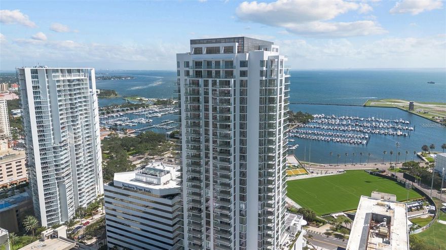SALTAIRE, the pinnacle of luxury living, has arrived to redefine upscale living in the heart of Downtown St Petersburg. ATTENTION RACE FANS AND CAR ENTHUSIASTS: INCREDIBLE ST PETE GRAND PRIX RACE AND WATERFRONT VIEWS! Boasting a Walk Score of 9.5, this exclusive new building offers unparalleled convenience, with renowned restaurants, museums, the Mahaffey Theater, and sporting venues all within a leisurely stroll. Elevated on the 14th floor, this exceptional residence spans an impressive 2,712 sqft, making it the largest non-penthouse unit in the building. From its vantage point, revel in breathtaking panoramic views of Tampa Bay, the Albert Whitted Airport, and the USL Soccer- Tampa Bay Rowdies field, a daily spectacle that will leave you in awe. Designed to perfection, this residence features three bedrooms, each complemented by its own private bathroom, with an additional full bathroom for guests. A versatile den adds flexibility and is easily convertible into a fourth bedroom or a home office to suit your lifestyle. Exceeding $100,000 in private upgrades, this unit stands out among its peers. From the upgraded and unique tile in each bathroom to the 15 additional power outlets strategically placed throughout, every detail has been meticulously curated. Custom woodwork and backsplashes, courtesy of the owner's design and architecture company, add a touch of sophistication. Step inside to discover a custom-designed interior featuring "Sand Marfil" matte finish porcelain tile in the common areas and polished porcelain in the primary bathroom, with floor-to-ceiling walls for a seamless look. The kitchen and dry bar area showcase gorgeous Calacatta Gold Quartz countertops paired with high-gloss Nolte premium European white cabinetry, complete with full-extension, soft-close drawers. Equipped with Jenn-Aire appliances, including the latest induction stove top and under-counter wine cooler, this kitchen is a culinary enthusiast's dream. A unique frosted door provides privacy and natural light to the den, creating the perfect workspace. Saltaire offers a host of amenities designed for modern living, including valet parking, a twenty-four-hour concierge, a state-of-the-art fitness center with peloton bikes, a chic pool and spa area with cabanas and barbecues, and a luxurious club room with an outdoor dining space and barbecue. Embrace a new chapter of luxurious living in St. Petersburg, Florida, with this spectacular residence at Saltaire. Schedule your showing today and elevate your lifestyle to new heights!