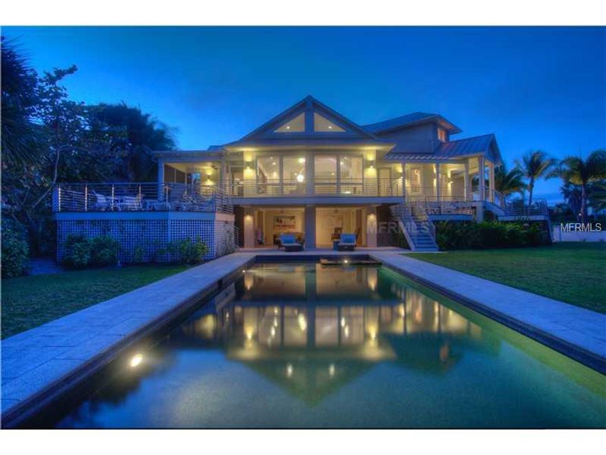 BOCA GRANDE, GASPARILLA ISLAND ... Classic Florida Contemporary! If you are looking for high quality, new construction ... this is it! Spectacular sunrises over Lake Gasparilla in this 3 bedroom, 3 ½ bathroom plus den/office/ 4th bedroom home. Serene and modern décor with very clean lines and soaring ceilings! Spectacular features include; Granite built-in kitchen with banquette, Wolf gas range, Coral stone gas fire place, formal dining room off the open living/kitchen area, Anderson windows and doors with maximum light, Peruvian mahogany flooring, IPE and Trex decking, Master Suites on both living levels, elevator, in-ground pool/spa within a walled/fenced-in and lush tropical landscape, 3 car plus golf cart garage and much, much more! Seller also owns a condominium boat slip nearby.