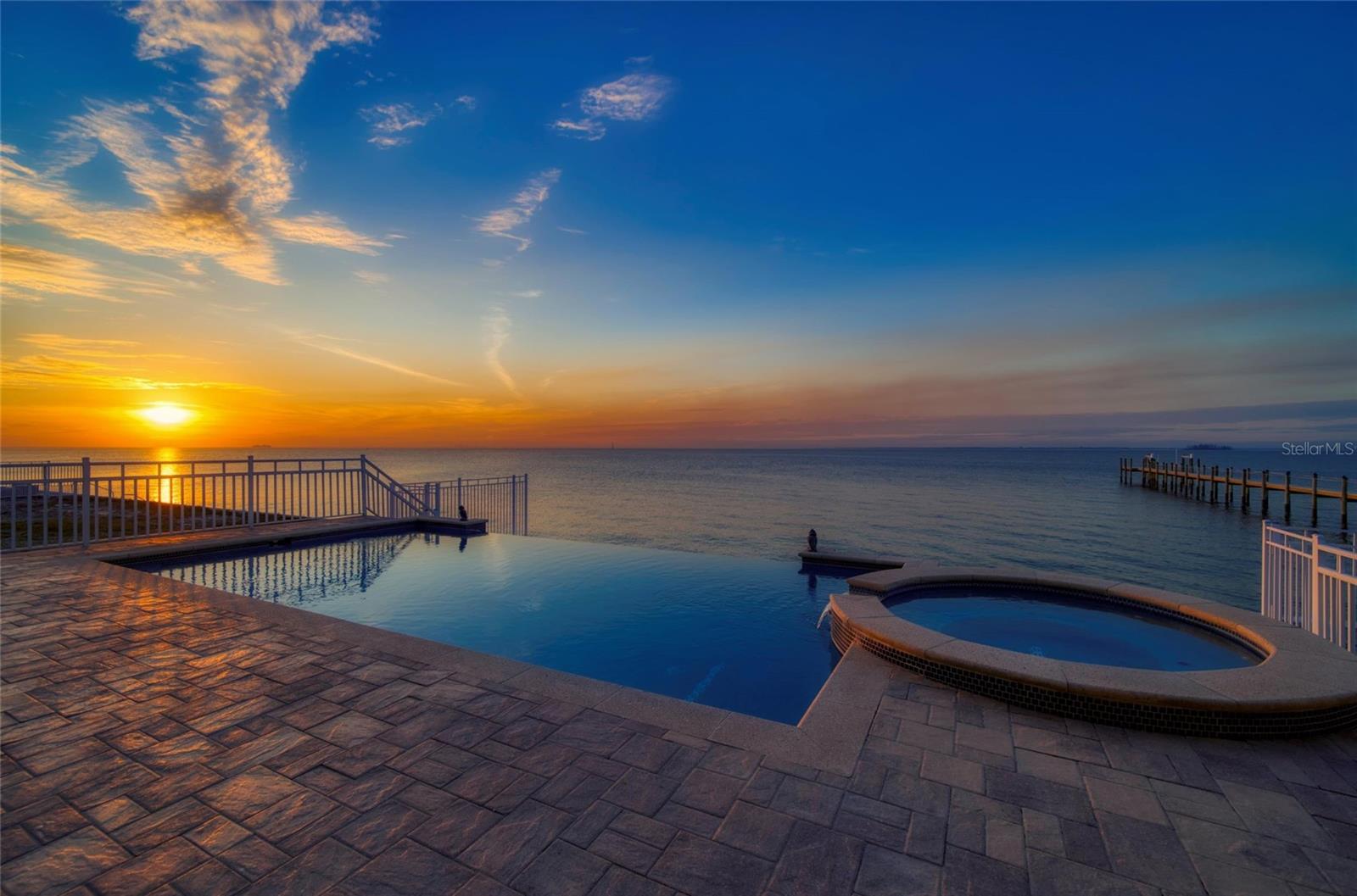 EXPERIENCE UNPARALLELED LUXURY IN THIS BREATHTAKING 5856 SQ FT ESTATE LOCATED DIRECLTY ON THE SERENE WATERS OF TAMPA BAY. This exquisite residence is in a GATED COMMUNITY boasting 4 spacious bedrooms, 5 full baths and 2 half bathrooms, offering ample space for both relaxation and entertainment. The majestic open-concept layout features high ceilings, an ELEVATOR, premium finishes and expansive windows that flood the home with natural light and offers stunning bay views. The kitchen is a chef's dream come true, equipped with top-of-line appliances, custom cabinetry, and a large island. The majority of the floors throughout are either Travertine or Engineered Hardwood. Retreat to your private sanctuary in the primary suite, complete with a spa-like bathroom, large walk in closet, fireplace & private balcony overlooking the bay. All bedrooms are complete with with it's own ensuite bathroom and private balcony. Dive into the ultimate relaxation experience with your own INFINITY POOL AND SPA, seamlessly blending with the waterfront views. The large patio includes outdoor kitchen and plenty of room for dining and entertaining. This exterior of this SOLID BLOCK home was just freshly painted with Mediterranean flare. Complete with IMPACT-RATED windows, energy-efficient ICYNENE FOAM insulation, TANKLESS HOT WATER HEATER, UPPER A/C UNIT REPLACED 6 moths ago, BRAND NEW POOL HEATER & LIGHTS. This exceptional property is a rare find, offering luxury, comfort and the ULTIMATE WATERFRONT LIFESTYLE. Contact me today to schedule a private tour and experience this magnificent home firsthand. SHORT TERM RENTALS ALLOWED.