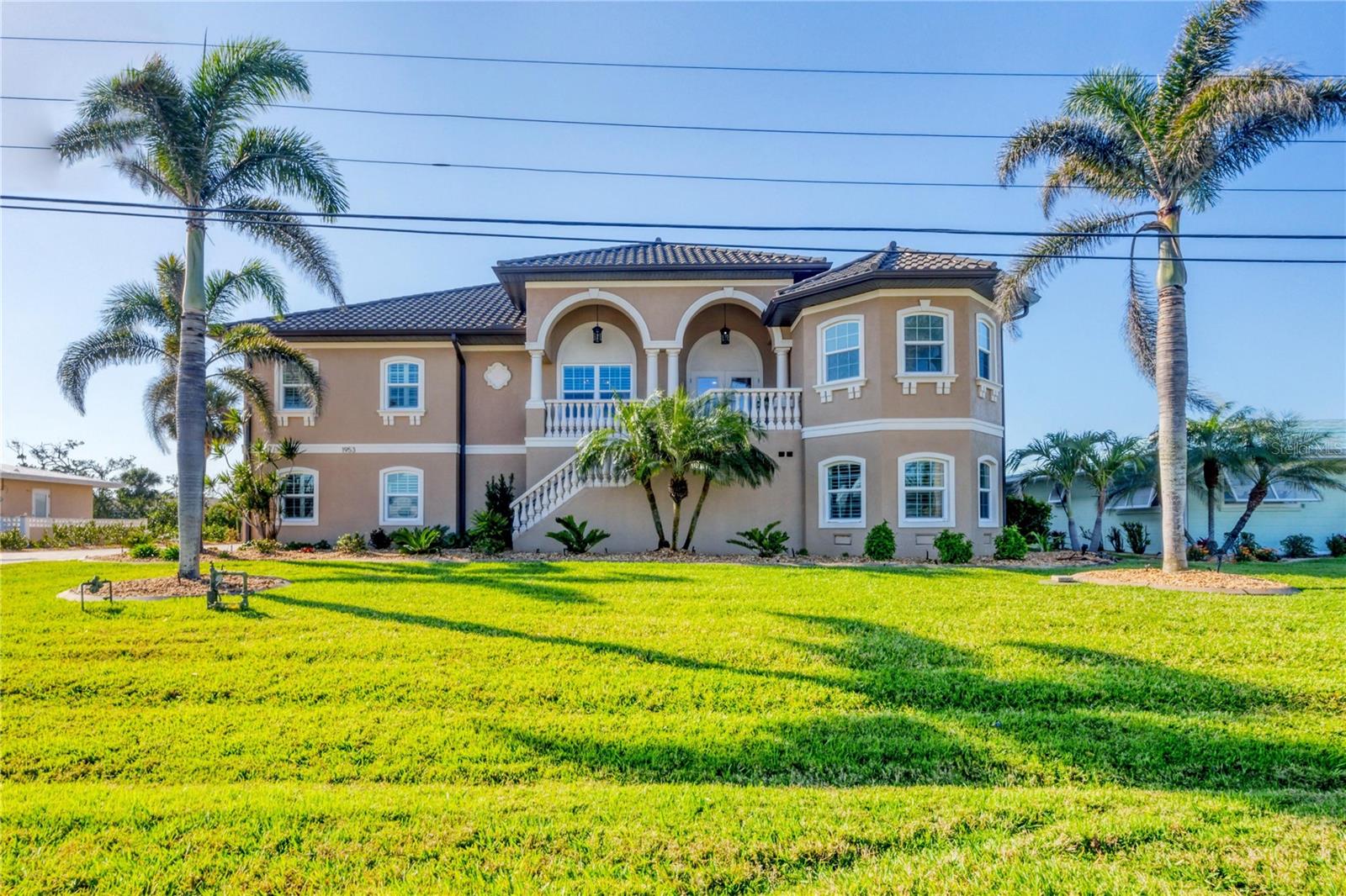Absolutely stunning! This beautiful waterfront home offers the luxury coastal lifestyle you have always dreamed of. The tile metal roof, classic columns and grand entrance are just the start. The paver driveway leads you to a 4+ vehicle garage including a climate-controlled area for your cars, a gym or project area. Take the birch lined elevator or stairs to the main floor and experience stunning views and seamless design. Breathtaking wide water and Lemon Bay views are showcased through hurricane impact windows and sliding doors. Multiple living areas flow effortlessly into one another leading out to a gorgeous, very rare, second level, south facing lanai and pool. Perched perfectly for privacy and panoramic views, this lanai offers a solar heated salt water pool, Hot Springs spa, and outdoor kitchen offering the ideal setting to unwind while taking in evening sunsets. Lower your covered boatlift, jump on your boat and enjoy quick access to Lemon Bay, Stump Pass and the Gulf of America. The kayak/paddle board lift and launch are convenient especially on calm mornings, the best time to spot the abundant wildlife in the area. The home features a Generac standby generator and superior solid construction including concrete block exterior walls, spray foamed sealed roof, and sliding metal shutters that completely enclose the back lanai seating area. A few recent upgrades include: new hurricane rated Decra roof (2022), generator (2025), Hvac system(2023), hot water heater (2025), newer sea wall. As a bonus, this home is a Silver rated Certified Florida Green Home which is a testament to the energy efficiency, durability and build quality. This is a truly unique opportunity to own a one of kind home. Whether you're soaking in the scenic beauty, hosting friends, or simply enjoying the quality of a well built home, this is a place where comfort and confidence come together. Your perfect waterfront home awaits.