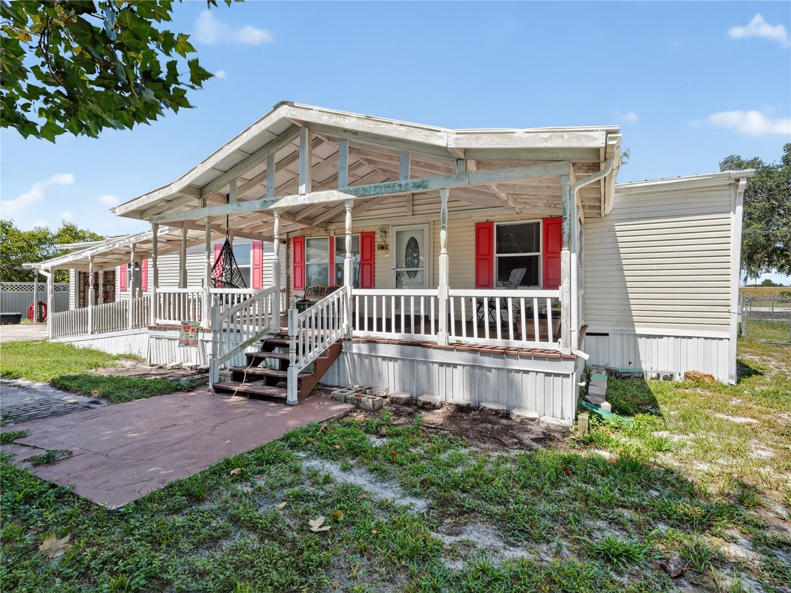 Enjoy the perfect blend of country charm and city convenience in this well-maintained 3-bedroom, 2-bath manufactured home. Located just minutes from downtown Winter Haven, the scenic shores of Lake Hancock, and a short drive to Legoland, this property offers both comfort and convenience.
Step inside to an inviting L-shaped living and dining room, with the kitchen opening to the living space through a cozy breakfast bar. The master suite features a walk-in closet and a private en-suite bath, while the inside laundry room adds everyday ease.
Outside, you’ll love the large covered front porch—accessible by both steps and a ramp—overlooking a fully fenced yard. The property includes a covered carport, a one-car garage, and nearly an acre of space to spread out. With a durable metal roof, septic system, and well water, this home is built for low-maintenance living.
Don’t miss this opportunity for space, privacy, and a great location!
